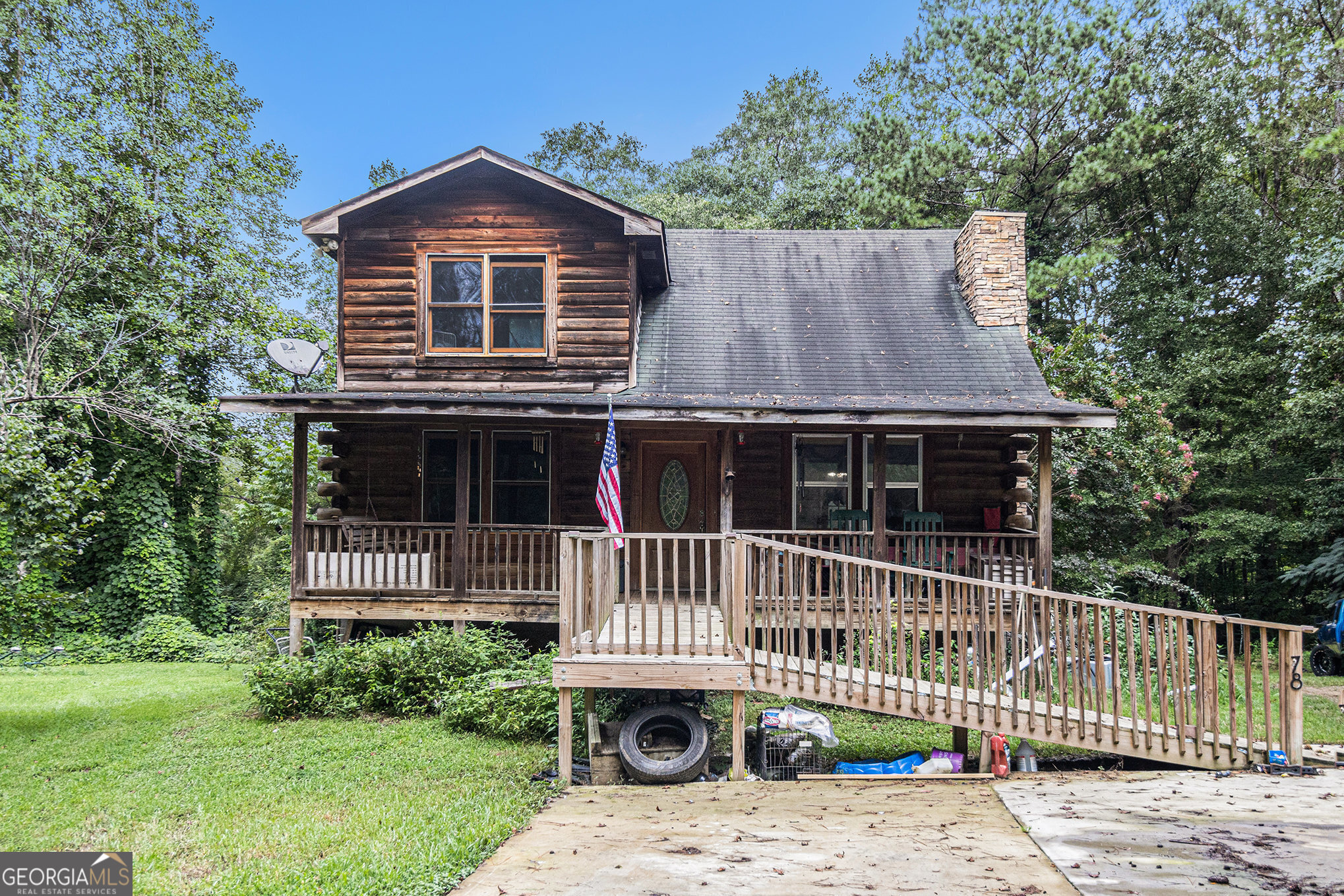 Your Chance to own a Custom Cyprus log home w/ 4 BR & 4.5 BA conveniently located in Tallapoosa. Accessible bedroom and bath on main floor. Ramp entry from easy to navigate concrete drive to a full length covered front porch. Great for a family with a loved one with mobility challenges. This cabin is built with Cypress logs, Cypress is exceptionally stable, more resistant to splitting and warping and has a natural resistance to insect infestation. Step into the too story entry with open beams and beautiful wood cathedral ceiling. A Large gas log fireplace catches the eye immediately upon entering. .Each bedroom has its own bathroom and walk-in closet. Downstairs master was recently redone with a walk-in tub(The 2nd master has an antique 1940's footed tub.) The other downstairs bath has been redone as well. It also has a large bonus loft room that makes an excellent office/playroom or 5th bedroom. Open floor plan with living room, dining room and kitchen. The kitchen has stainless steel appliances recently updated. Separate Laundry/mud room with half bath. It sits atop a full poured concrete basement with roll up entry and walk in entry. Partially finished basement with a workshop. New water heater & faucets in upstairs master & kitchen New concrete drive Front porch, back deck, Beautiful creek and Koi Pond for quiet relaxation City water, sewer and gas without city taxes. Halfway between Atlanta and Birmingham and Chattanooga and Columbus Within walking distance of Dub Denman canoe trail on the Tallapoosa River This property would be great for a family with a child or aging parents with mobility needs. It would also make a profitable AirBNB