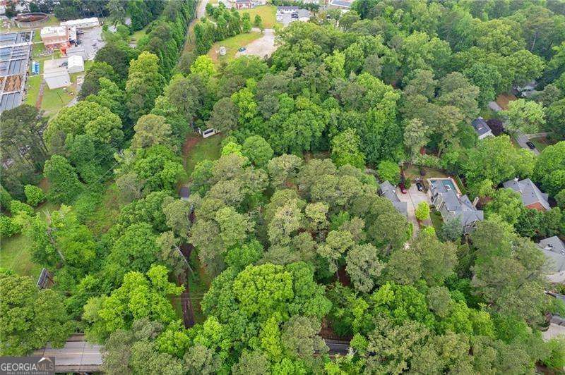 Rare Opportunity in Morris Brandon School District - Don't miss your chance to build your dream home on nearly a full acre in the highly sought-after Morris Brandon school district! Tucked away in a serene, wooded setting, this level homesite offers the perfect blend of privacy and possibility. With water and sewer already in place, this lot is ready for your custom vision-whether it's a luxurious estate or a private retreat nestled among the trees. Opportunities like this are few and far between in this prestigious area. Homesites of this size and location rarely become available. Let's make your dream home a reality-contact me today before it's gone! A survey is available upon request. The adjoining lot with the home is being sold seperately or can be sold together.