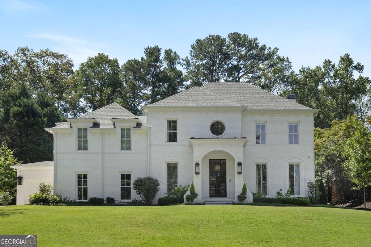 Stunning Custom New Construction in the Heart of Sandy Springs! Welcome to this exceptional 6 bedroom, 6.5 bathroom home designed by Linda MacArthur and built in 2022 by EverCraft Custom Builders. Located in the coveted Heards Ferry Elementary district and just minutes from Atlanta Country Club, Holy Innocents, Mount Vernon, Temple Sinai, and more, this residence offers unmatched convenience and elegance. From the all-brick exterior with wrought iron doors and gas lanterns to the mature landscaping, the curb appeal is second to none. Inside, soaring ceilings, an open floor plan, and wide-plank white oak floors set the tone for the home's timeless yet modern design. The main level showcases a chef's kitchen with custom cabinetry by Bell Kitchen & Designs, Sub-Zero and Wolf appliances, and a seamless flow into the living area and covered porch. The oversized owner's suite is a true retreat, featuring a spa-inspired bath with soaking tub, frameless shower, expansive double vanities, and dual custom walk-in closets. Two half baths, a mudroom, and a laundry area complete the main level. Upstairs, four spacious bedrooms and three full bathrooms are complemented by a dedicated home office and flex space. One of the bedrooms is oversized and offers versatility as a playroom, gym, or additional office, and the second laundry room provides everyday convenience. The outdoor living space is second to none. A 15-foot accordion glass door opens to a covered screened-in porch with Ipe flooring and a 42-inch gas fireplace. Beyond the porch lies a resort-like setting, with a saltwater heated pebble tech pool edged with Hartstone coping, a fully turfed surround, gazebo, custom grilling station, landscape lighting and even a putting green. The fully finished terrace level extends the home's entertainment and lifestyle options, featuring a large entertaining area, full kitchen, home gym with infrared sauna and cold plunge, Trackman Golf Simulator, rec room, and an in-law suite (full bathroom, bedroom and entryway) with private entry. An attached three-car garage rounds out this extraordinary home, which is truly move-in ready with every luxury detail thoughtfully designed.