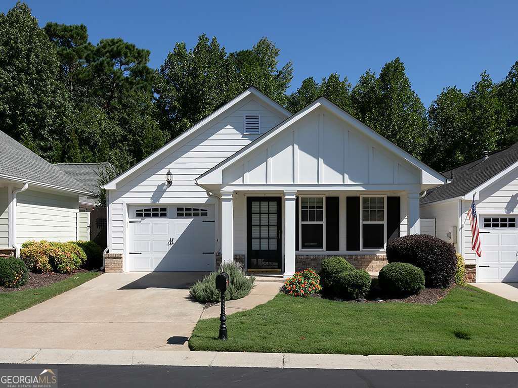 Welcome to Montclair at Ridgewalk, a Windsong Property. Come visit this small, quiet community in Woodstock. The neighborhood consists of charming, low-maintenance homes surrounded by immaculate landscaping. This beautiful stepless newly painted 2 bedroom, 2 bath ranch home is amazing! Hardwood floors throughout and new carpet in the bedrooms/family room. This lovely ranch has an open family room with lots of natural light, inviting foyer area, large open kitchen with breakfast room, a breakfast bar, cherry cabinets and newer countertops and pantry. Kitchen has an electric stove/oven. But, don't worry it can be switched over to gas. Laundry closet is off the kitchen. Vinyl tile garage floor. And, enjoy the large primary suite with sitting room/office with ensuite bathroom, double vanity, shower and the perfect walk-in closet with custom built shelving and wardrobe space. This is definitely a must-see! Across the hall is the guest bedroom with a full bath. And, for the outdoor enthusiast, take in the private courtyard/side porch area with arbor. Perfect for gardening or outdoor entertaining with friends and family. And, don't forget to check out the Communities Clubhouse which includes a fitness room, library, and a sitting room where homeowners can visit with their neighbors or enjoy watching the large-screen TV. The subdivision, located within walking distance to the Outlet Shoppes of Atlanta, is just minutes from highways 575 and 92. It is also a short drive to historic downtown Woodstock, numerous stores and restaurants. And lastly, Woodstock offers easy access to downtown Atlanta to the south and the Georgia Mountains to the north. Living at it's very best!