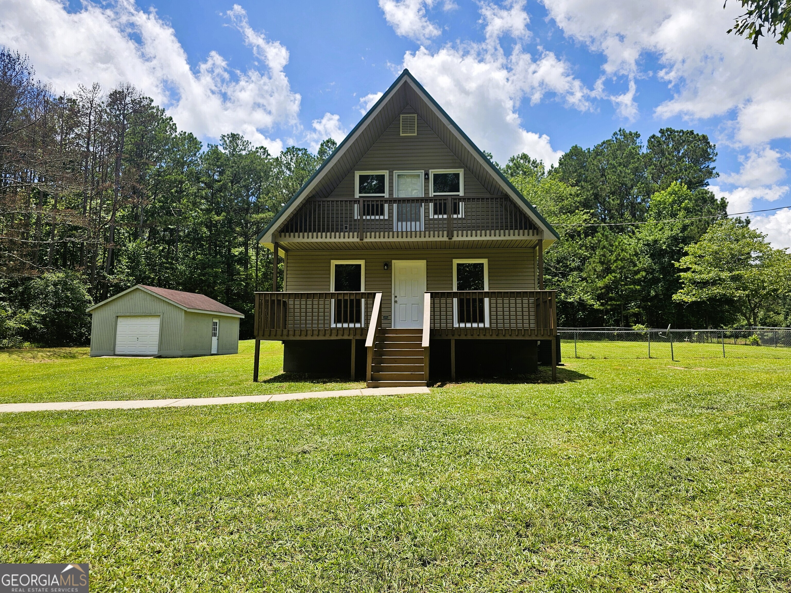 Adorable and fully renovated, this 3-bedroom, 1.5-bath A-frame home offers a cozy living space with modern updates throughout. The inviting family room features a beautiful stone fireplace, and the fully renovated kitchen includes new cabinets, granite countertops, and stainless steel appliances. The main level has one bedroom and a full bath, while the two additional bedrooms are upstairs along with a half bath-one of the upstairs bedrooms includes a large walk-in closet and private balcony. Upgrades include new LVP flooring in the main areas, new carpet in the bedrooms, new bathroom vanity, new HVAC, water heater, windows, fresh interior and exterior paint, updated fixtures, and more. Situated on a large, level 1.85-acre lot with a fenced backyard and an 18x20 detached garage/storage building. Located within walking distance to Jellystone Park and just minutes to I-20 for an easy commute. Move-in ready and full of character-this home is a must-see! FHA Eligible: 8/5/25