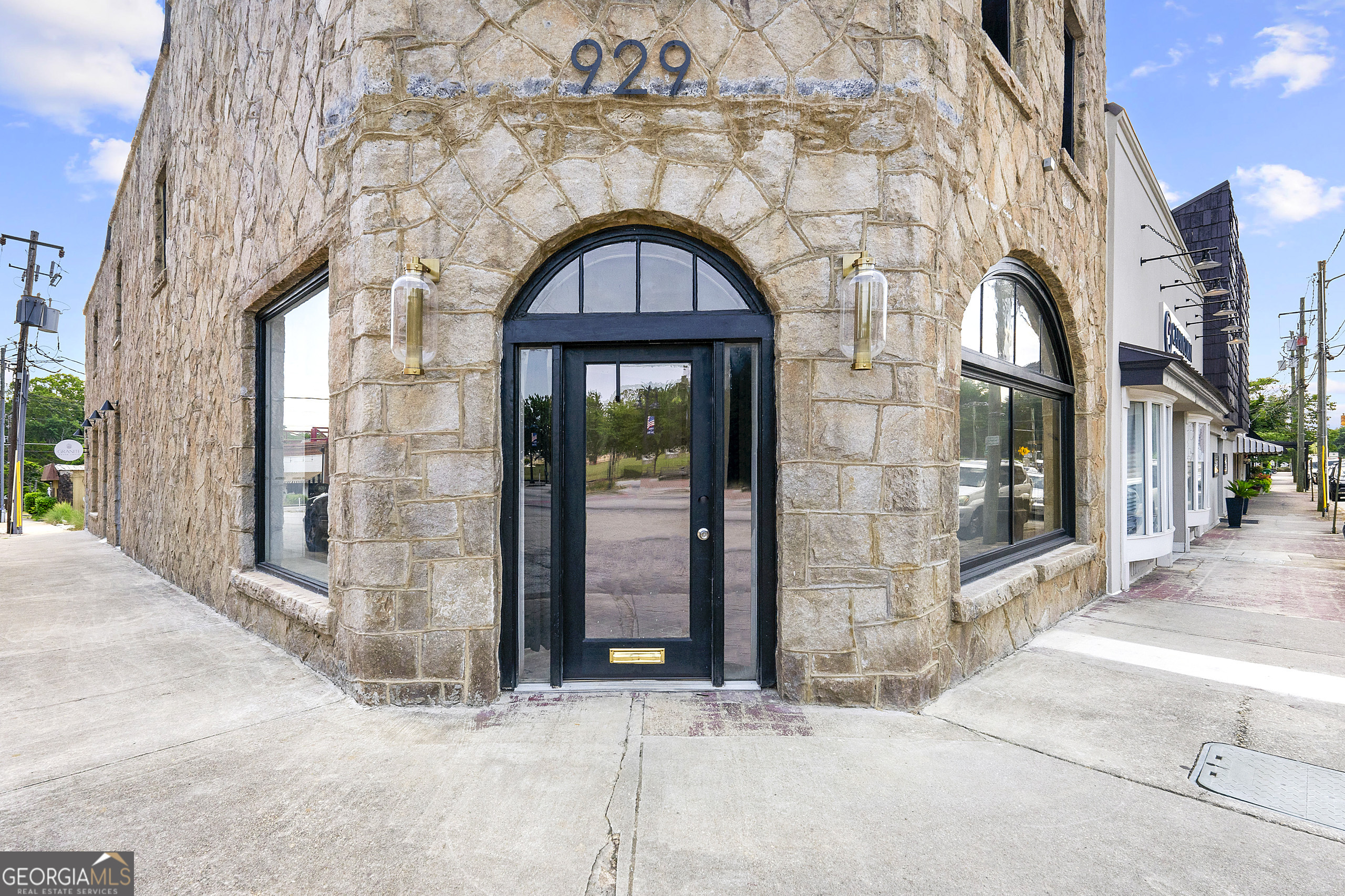 Welcome to 929 Main Street, a prime leasing opportunity in the heart of Downtown Stone Mountain Village. This two-story, full-granite building is located at a bustling corner on Main Street, providing unparalleled visibility and accessibility. Perfect for a restaurant, boutique retail store, spa, or other unique business concepts, this space is ready to be transformed to suit your needs. Key Features: Prime Location: Just steps away from Stone Mountain Park, a major tourist attraction drawing millions of visitors annually. High Foot Traffic: Benefit from the constant flow of tourists and locals exploring the vibrant downtown area. Flexible Space: The shell space is ideal for a custom build-out, tailored to your business vision, whether it's a trendy restaurant, a chic boutique, or a serene spa. Historic Charm: The building's full-granite exterior offers a distinctive and attractive presence. Space Details: Shell Condition: Requires mechanical, electrical, and plumbing installation. Gas, water, and electrical services are available, with established chases for HVAC to the roof. Parking Convenience: Ample street parking on both sides of the building and two parking lots directly across the street. Financial Incentives: Rent Deferment: The landlord offers a rent deferment option in lieu of tenant improvements, providing flexibility to invest in your personalized build-out.