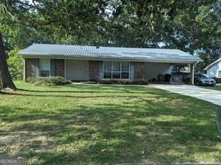 Located in Garden Lakes Subdivision. 3 bedroom 2 bath,4 sided brick home with metal roof. Fenced back yard, with 2 storage buildings and shade trees. 2 car carport. Within minutes to shopping and resturants. West End Elementary School, Rome Middle School and Rome High School district.