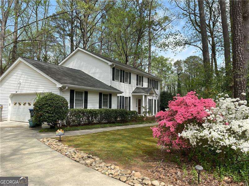 MOTIVATED SELLER!!: A must-see southern traditional located just off Marietta's tree-lined Old Sewell Road, this lovingly maintained home radiates warmth and timeless charm. Offering an inviting blend of classic architecture and thoughtful updates that honor its heritage. You are greeted by lush gardens that frame the front of this lovely home, while four stately porch columns welcome you like old friends. Step inside and take your time-almost every room has been preserved in impeccable condition, from the rich, solid wood floors to the freshly painted walls. The care poured into this home is evident in every detail. Enjoy spacious rooms, fresh updates, and abundant storage throughout. PLEASE NOTE: Although the title says 3 bathrooms, there are 4 bathrooms in the home... 2 full bathrooms upstairs, a half bathroom on the main and a 3/4s bathroom in the basement. The family room invites cozy evenings with its warm fireplace, custom cabinetry, built-in bookshelves, and a welcoming wet bar. Just beyond, a sun-drenched plant room-lit by skylights and overlooking a serene bamboo grove-offers the perfect nook for quiet afternoon reading. The kitchen is thoughtfully designed with a seated island, abundant storage, and an eat-in bay window that frames a gorgeous view of the expansive backyard. Head upstairs to discover four spacious bedrooms, each with its own distinct personality. The master with ensuite and additional full bath are on this level. Downstairs, the spacious finished basement includes a convenient three-quarter bath-ideal for washing up after gardening. Step out through the large screened-in porch, where a freshwater spa awaits. Stone pavers guide you to an oversized shed surrounded by lush greenery. While you explore, take a moment to see how many plant varieties you can spot-every corner of this property whispers of the love and attention it's received. From the moment you step inside, you will feel the warmth and affection that make this house a true home.