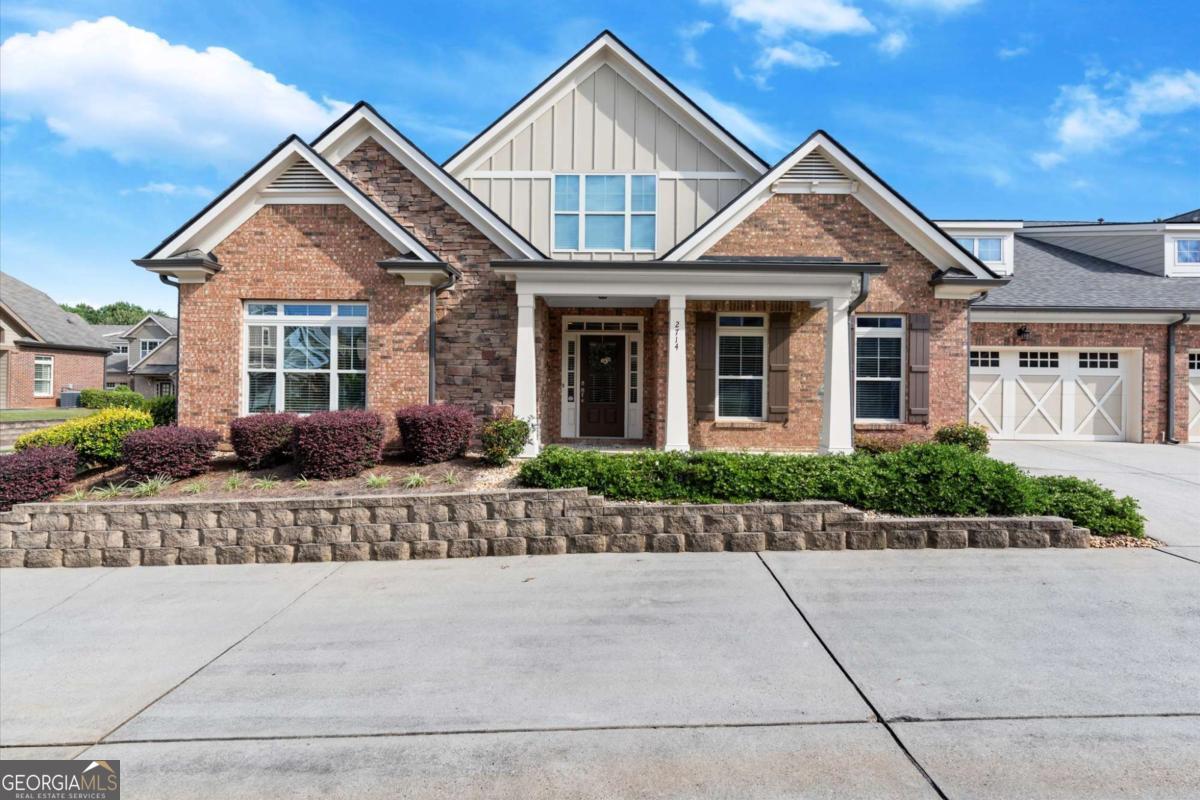 Welcome home! Move-in ready 3BR/3BA home in the sought-after Wellstone 55+ community! The entire home has been freshly painted and features a brand new roof! Main level features primary suite with ensuite bathroom, plus secondary bed/bath. Step out to the inviting screened porch from the secondary bedroom or the great room. The kitchen boasts granite countertops, ample cabinets & opens to the great room with a gas fireplace. Upstairs offers a 3rd bed/bath & large walk-in storage room that could be finished for more living space. Oversized garage with extra storage/workshop area. HOA covers exterior maintenance, insurance, termite & trash. Community amenities include saltwater pool, hot tub, clubhouse, garden & sidewalks. Convenient to shopping, dining, medical & GA 400/Northside Forsyth-country feel with close-in convenience!