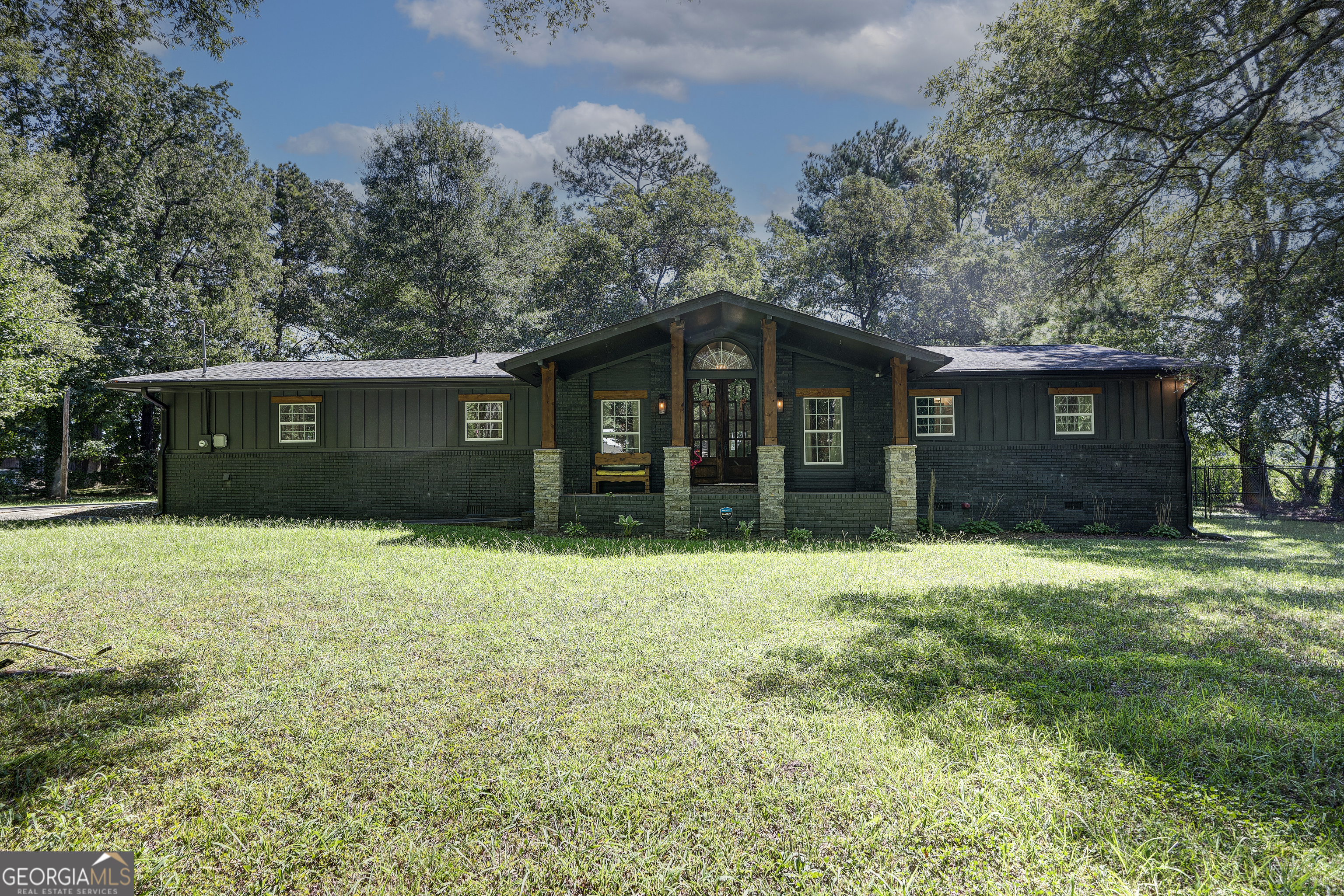 EXQUISITE, MAGAZINE-WORTHY RENOVATION WITH INDOOR AND OUTDOOR LIVING SPACES! Perfectly positioned amidst a SPACIOUS, LEVEL LOT, this ONE -LEVEL rancher has been thoughtfully remastered from top to bottom, with no attention to detail spared. The impressive exterior greets you with remarkable CURB APPEAL, featuring BRICK with faux STONE ACCENTS, WOODEN COLUMNS, and a notable, rich hue. From the ROCKING CHAIR FRONT PORCH, guests embark through the wooden and glass DOUBLE ENTRY DOORS and are welcomed into the WIDE-OPEN-CONCEPT FOOTPRINT with brilliant NATURAL LIGHTING, PERFECT FOR ENTERTAINING and everyday living. The OPULENT KITCHEN is ideal for cooking enthusiasts, and is equipped with QUARTZ COUNTERS; STAINLESS APPLIANCE PACKAGE; CABINET-SPACE GALORE with SOFT-CLOSE options; and generous PREP ISLAND with BREAKFAST BAR SEATING for 5, providing a place of congregation. It effortlessly spills into the LIVING ROOM, with DECORATIVE FIREPLACE serving as the focal point. The VAULTED, TONGUE-AND-GROOVE CEILINGS are crafted with WHITE-WASHED PINE and accentuated by handsome BEAMS. The DINING AREA is embellished with dapper JUDGES PANELING, creating a timeless ambiance for memorable meals. LUXURIOUS LAUNDRY/MUDROOM is positioned just off the garage, including BUILT-IN HANGING LOCKERS and UTILITY SINK. On the opposite end of the structure, you will discover the home's sleeping quarters. The OWNER'S SUITE features a spacious bedroom with whitewashed pine ceiling, and PRIVATE ENSUITE with tub/shower combo, boasting handsome TILE SURROUND. The secondary bedrooms are generously-sized (one with 2 closets), and share a hall bath with SIT-DOWN MAKE-UP STATION. ENJOY FALL FOOTBALL and OUTDOOR ENTERTAINING on the COVERED BACK PORCH, overlooking the FENCED BACKYARD. Additional Highlights include: No HOA; 2-car garage; Total electric home; Refrigerator in kitchen can stay for new buyer, if desired. Discover TIMELESS BEAUTY and modern luxury as you tour this incredible property, which is positioned in the county, but adjacent to city property. Welcome Home to 133 Kentucky Drive!
