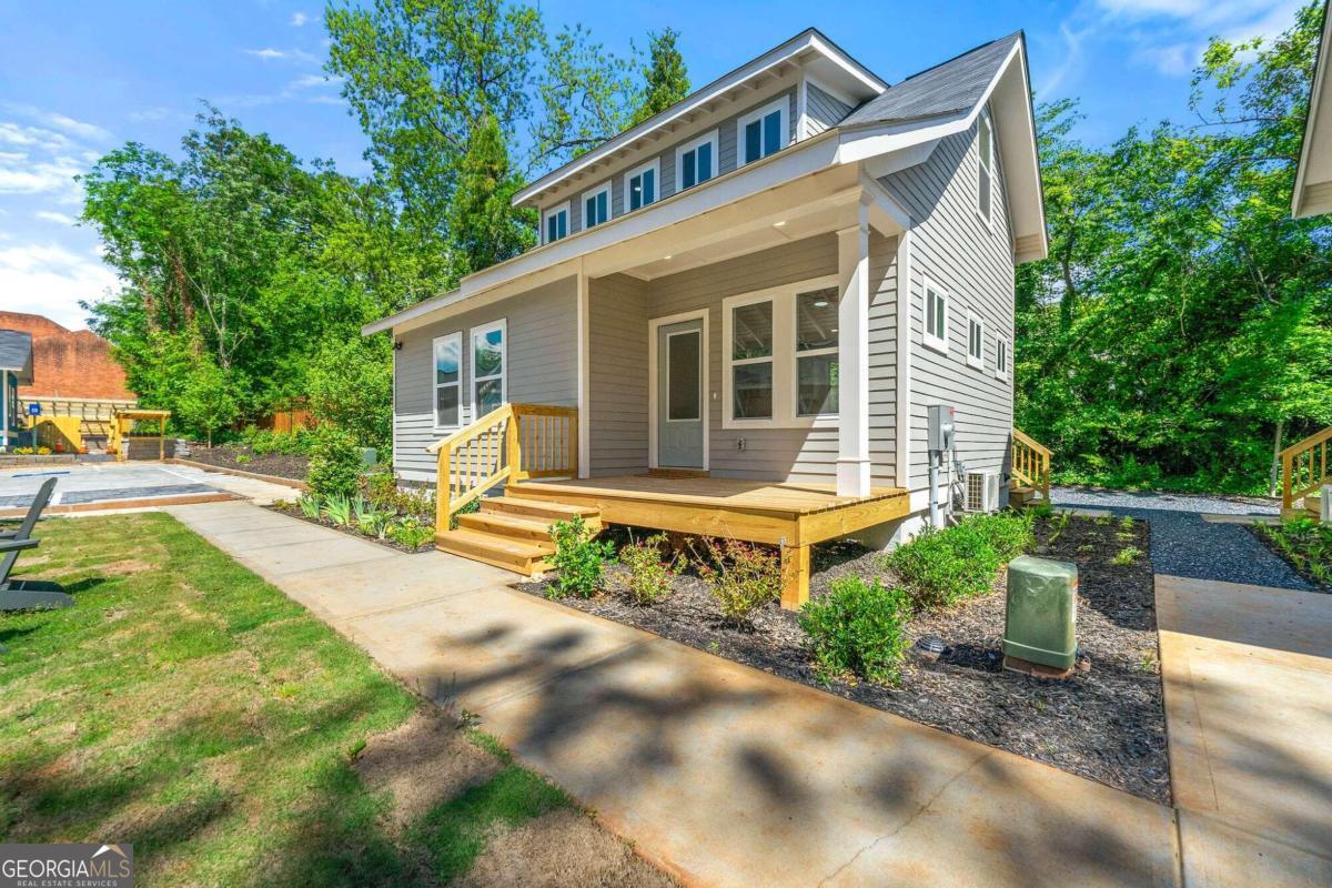 Oak Cottage Court is a charming pocket neighborhood affordably priced in City of Decatur. A collection of 6 versatile, green-built, single family cottages.    Introducing 214 Commerce Dr., a new construction 2-story home featuring 3 bedrooms and 2 bathrooms. This modern home boasts an open floor plan with contemporary finishes, stone countertops, and a charming front porch perfect for relaxation. Enjoy the convenience of walking to downtown Decatur's award-winning restaurants, MARTA, schools, and parks.      Please note, buyer`s income must not exceed 100% of the Area Median Income (AMI). Check full prerequisites at the Decatur Land Trust website. All photos in this listing are sample images and may not be the specific house available. The images represent one of the six houses in the development. Actual layouts and features may vary. Buyers must attend an online home purchase information session, visit the Decatur Land Trust website for the schedule. If after attending the online information session the buyer wishes to make an offer on a property, fill out the online application with requested income information. If buyer meets the income requirements, buyer will be connected to the preferred lender for prequalification. Offers will NOT be accepted without prequalification from the preferred lender. Offers will be considered for any interested parties who've attended an info session, completed the Land Trust application, and obtained a prequalification letter from our preferred lender. Special: $5k seller concession that can be paired with any other program for offers written by 10/31.