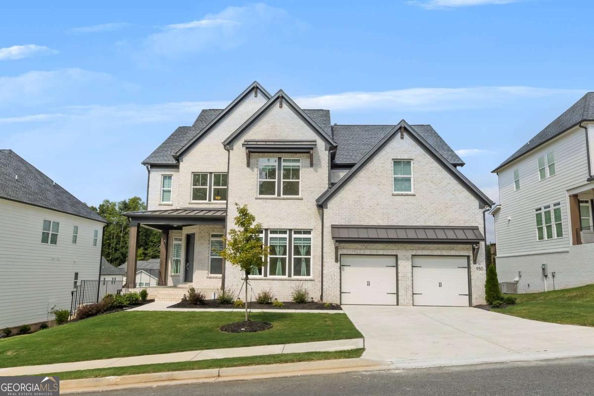 The stunning Hendricks floorplan, part of the Highland Collection in the sought-after Vista Ridge community, offers elegance and functionality in a prime Woodstock location. Perfectly positioned between Downtown Woodstock, Downtown Roswell, and Crabapple, this master-planned community provides both convenience and lifestyle. The distinctive Hendricks welcomes you with a charming front porch and soaring two-story foyer that opens to a spacious dining room. A private flex space or office is located just off the entry. The expansive two-story great room, highlighted by a striking tile-surround fireplace, flows seamlessly into the well-appointed kitchen and casual dining area. From here, enjoy access to the rear deck, ideal for morning coffee or evening grilling. The chef's kitchen features a large center island with breakfast bar, abundant upgraded cabinetry and countertops, and a premium 36" KitchenAid gas cooktop. A secluded first-floor bedroom with full bath provides the perfect guest retreat, while the owner's entry from the two-car garage-complete with an electric car charging outlet-adds everyday convenience. Upstairs, the private owner's retreat impresses with a tray ceiling, generous walk-in closet, and a luxurious spa-inspired bath with dual vanities, soaking tub, glass-enclosed shower, and private water closet. Secondary bedrooms include one with a private bath and two sharing a hall bath, each with walk-in closets. A centrally located laundry room with sink and storage completes the upper level. The full, unfinished walkout basement offers endless possibilities for future living space. This spectacular home has over $200,000 in new construction upgrades, please refer to the information sheet in documents for a complete list. Residents of Vista Ridge enjoy resort-style amenities including a clubhouse, pool, cabana, Cornhole court, and playground. With recreation, shopping, dining, and entertainment just minutes away, this home blends upscale living with an unbeatable location.