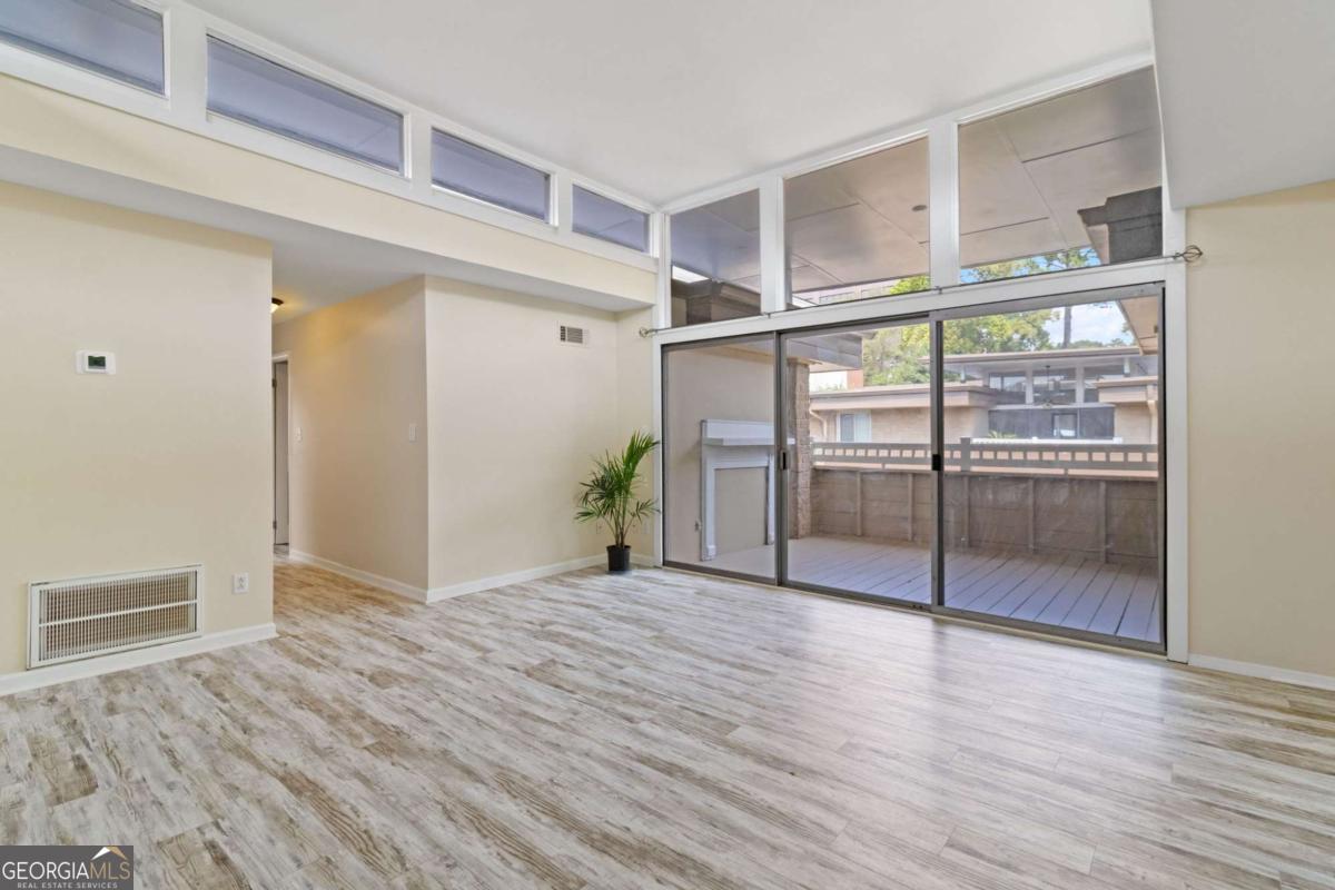 Step into mid-century charm with modern comfort in this beautifully updated 2-bedroom, 2-bath condo in the coveted Laurel Grove community. Designed by Robert Green (a protege of Frank Lloyd Wright), this home delivers architectural character with high clerestory ceilings, abundant natural light, and an open layout that flows with ease. Enjoy a sundrenched great room that leads into a covered porch perfect for sipping morning coffee or unwinding in the evening. The kitchen boasts stone counters and sleek finishes; the bedrooms are well-proportioned, each with its own full bath. LVP flooring and designer touches throughout make this feel like a turnkey retreat. Key Features & Lifestyle Perks: Swimming pool in a gated, well-maintained community. Private, assigned parking with guest parking options. Outstanding location: minutes from Roswell Road, City Springs, parks, trails, shopping & dining. Easy freeway access (285, 400, 75/85) & proximity to public transit. This condo offers upscale, low-maintenance living without sacrificing character or convenience. Perfect for professionals, downsizers, or couples wanting Sandy Springs lifestyle at its best.