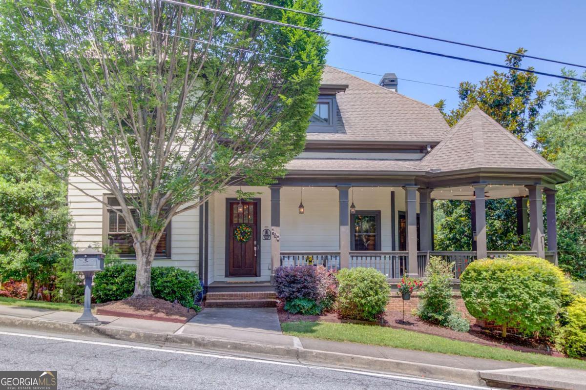 Walk to All of the Wonderful Restaurants, Coffee Shops, Boutiques and Parks in Historic Norcross! It's not Just a Neighborhood, it's a Lifestyle! Beautiful Craftsman Home Just Steps from Historic Downtown Norcross in Sought-After Lum Howell Park! Welcome to this stunning Craftsman-style home that perfectly blends modern design with timeless charm. Situated on a desirable corner lot in a quaint enclave of just 24 homes, this residence is nestled within a serene community that features its own private park. Imagine greeting neighbors and friends from your spacious front porch, complete with an expansive corner gazebo - perfect for morning coffee or evening chats. Gather around the outdoor fire table with family and friends for memorable evenings! Step inside to a grand two-story foyer and be welcomed by soaring 10-foot ceilings on both the main and upper levels. Walls of windows with elegant transoms fill the home with natural light, while exquisite architectural details - arched walkways, rounded wall corners, coffered ceilings, extensive crown molding, and 12" baseboards - showcase the craftsmanship and quality throughout. The gourmet kitchen is a chef's dream, featuring raised-panel cabinetry, granite countertops, a breakfast bar, stainless steel appliances, a five-burner gas range, and under-cabinet lighting. The open-concept layout on the main level is ideal for entertaining -- host guests in the welcoming front parlor, transition into the stylish family room, and enjoy meals in the adjoining dining area. Cap off your evening with after-dinner drinks on the oversized screened porch. Also on the main level, you'll find a full bathroom and a versatile bedroom/office, offering flexibility for guests or remote work. Upstairs, the luxurious primary suite is a true retreat with a double tray ceiling, a spacious, custom-designed walk-in closet, and your very own beverage bar featuring a wine refrigerator. The en suite bath offers a double vanity, soaking tub, and a separate walk-in shower. Two additional bedrooms, each with their own full bath, and a convenient laundry room complete the upper level. The finished terrace level includes a large living space or guest suite, a full bathroom, and a flexible room perfect for a gym, office, or hobby space. Outdoor living continues on the covered patio, enhanced by a full under-deck ceiling system. Located just a short walk to Historic Downtown Norcross, you'll love the easy access to fantastic restaurants, boutique shopping, Thrasher Park concerts and festivals, and Lillian Webb Park's vibrant community events. Zoned for Paul Duke High School! With an unbeatable location, charming architecture, and a warm community atmosphere-this home isn't just a place to live, it's a lifestyle!