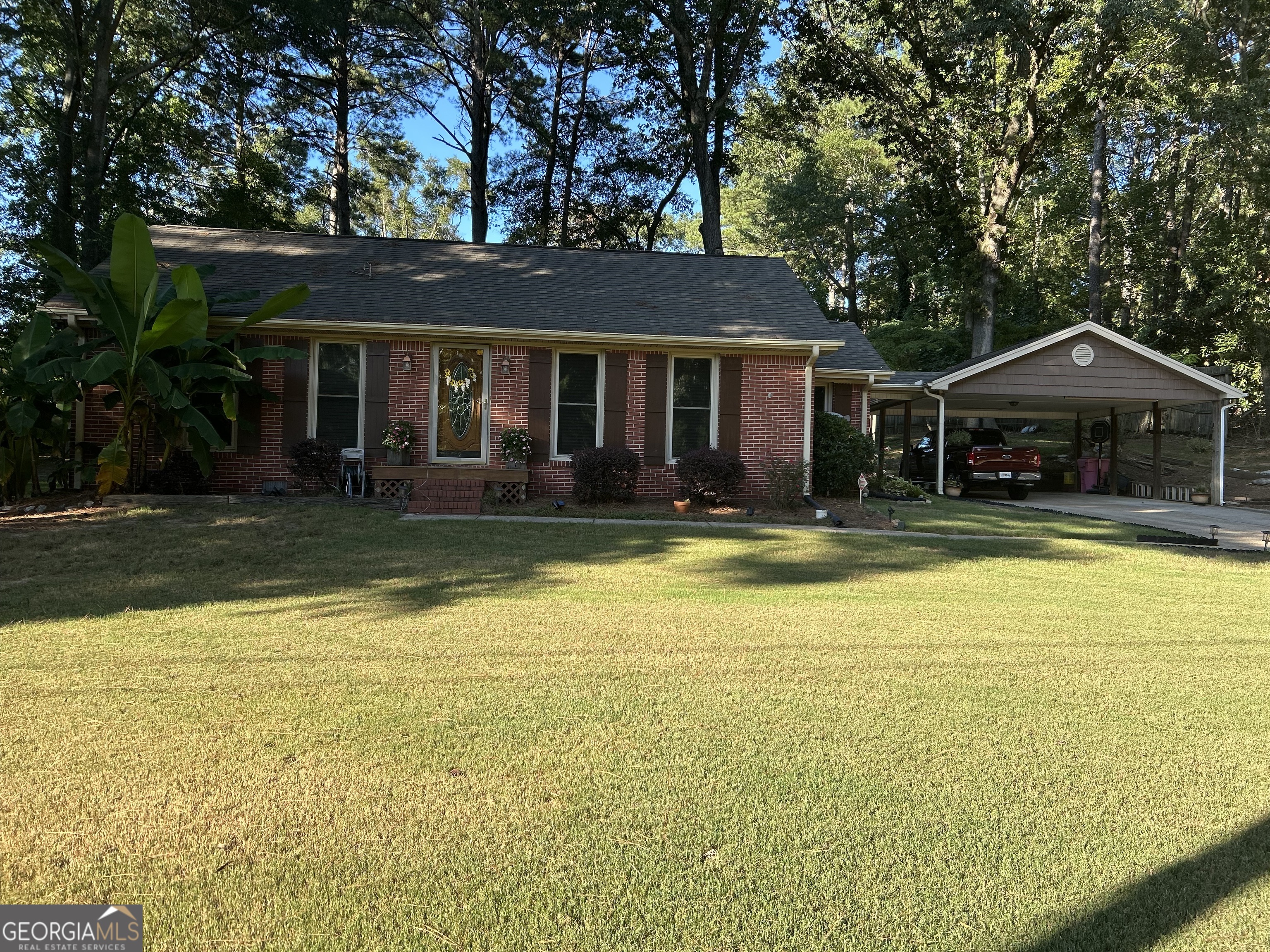 Immaculate and lovingly maintained, stepless home in Winder! 3 bedroom, 1 and 1/2 bath, kitchen with eating area, and family room. There are 3 large outbuildings with electricity and even a RV connection! Building #1 has double doors and is 10'x20', building #2 has a garage door and is 12'x32' with 2 lofts, and building #3 is 12'x16' with a four foot front porch. In addition, there is a beautiful outside entertainment area (outside kitchen equipment negotiable). This home is on a private lot that is close to schools and shopping! Has fencing but does not belong to this property. Probably won't see or hear cat but please be sure it doesn't get out. Call or Text Kathy for a showing before it gets away!