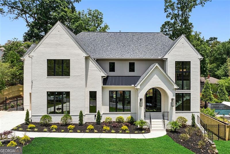 Welcome to this stunning custom home, meticulously crafted by White Oak Home Builders. Every inch of this 6-bedroom, 5.5-bath residence reflects timeless craftsmanship and refined luxury, seamlessly blending high-end design with everyday comfort. Step inside to find white oak flooring and finishes throughout, setting the tone for the home's cohesive, organic elegance. The expansive chef's kitchen is a showpiece, featuring custom cabinetry, paneled Sub-Zero refrigerators, a Wolf range, and a full Visual Comfort chandelier and pendant lighting package that elevates every space. Casement windows fill the home with natural light, highlighting the thoughtful details and premium materials at every turn. Spa-like bathrooms boast luxury plumbing fixtures and bespoke cabinetry, creating serene retreats throughout. Outside, the Pebble Tec pool and spa offer a private oasis with full automation, perfect for effortless entertaining. The professional landscaping is both beautiful and functional, enhanced by a fully automatic irrigation system, elegant gas lanterns, and landscape lighting that adds nighttime allure. From the striking curb appeal to the sophisticated interiors, this home is a rare opportunity to own a one-of-a-kind property built to the highest standard.