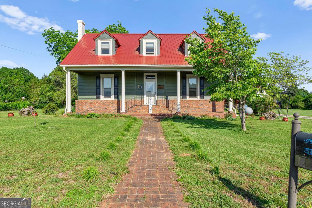 Welcome to your very own piece of heaven! This beautifully maintained 4-bedroom farmhouse is full of character and comfort, nestled on 3+ peaceful acres. From the moment you step onto the inviting rocking chair front porch, you'll feel right at home. Inside, a welcoming foyer opens to a spacious family room featuring gorgeous stained built-in cabinets and warm pine wood floors that flow throughout the home. The master suite and an additional guest bedroom are conveniently located on the main floor, with two additional oversized bedrooms located on the second floor. The renovated kitchen is a true showstopper-complete with granite countertops, new appliances, and plenty of space to gather and entertain. Cozy up during cooler months with not one, but two pellet stoves that add to the farmhouse charm. Enjoy year-round outdoor living on the screened porch or host family and friends on the expansive back deck. The property also features a large detached garage/storage building, a separate barn, fenced pasture area, and new metal roofs on both the home and barn. Whether you're looking for a quiet retreat, a mini farm, or space to spread out, this one-of-a-kind property has it all. Come see what country living is meant to feel like!