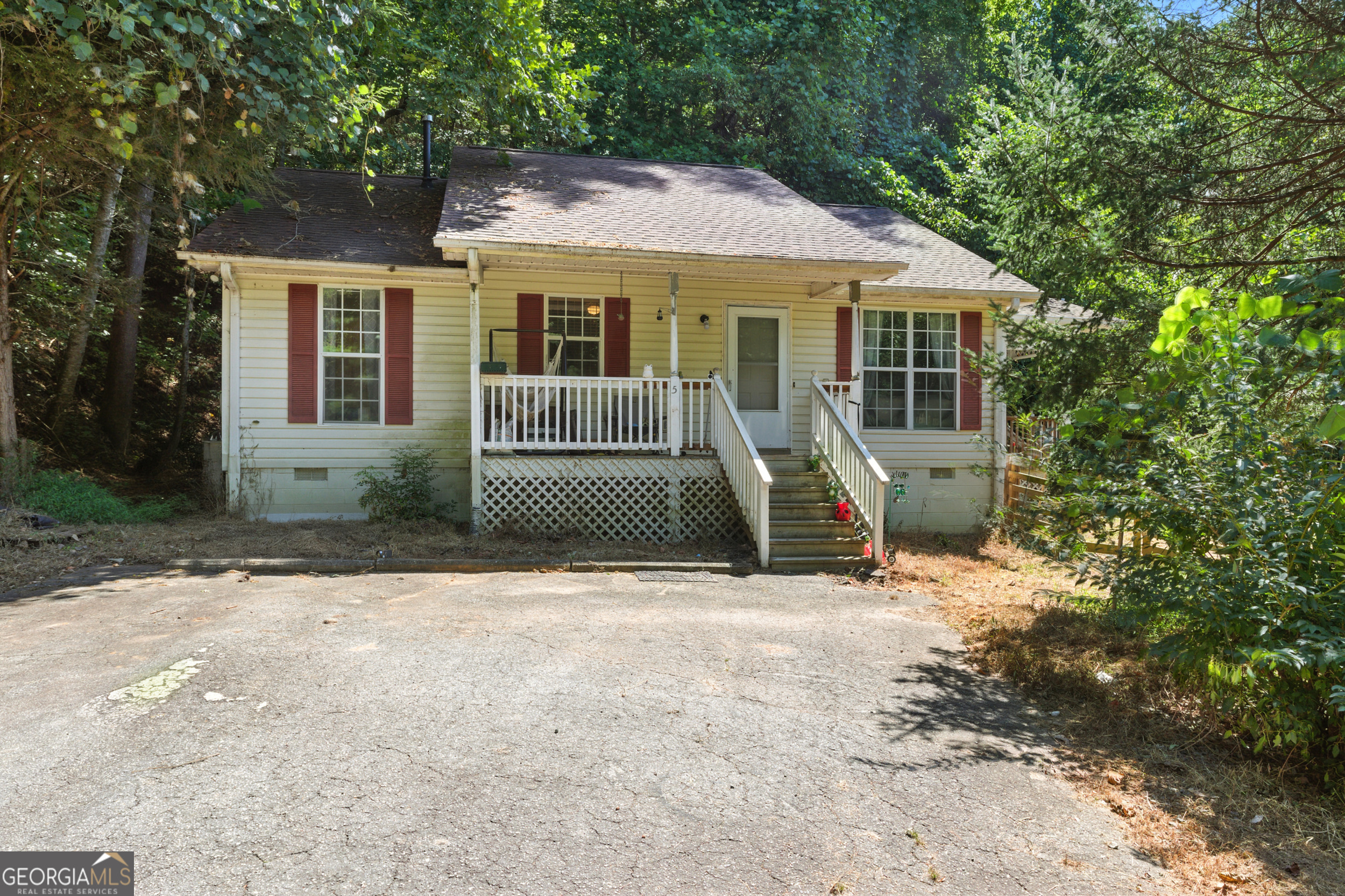 Looking for peace and quiet? This property delivers! Nestled on just over 3 acres, this charming home features 2 bedrooms, 1.5 bathrooms, and a flexible office or small guest room. The kitchen flows seamlessly into the dining area and den, creating a comfortable space for everyday living. Step out onto the covered porch to breathe in the fresh mountain air and take in views of the pond just down the driveway.