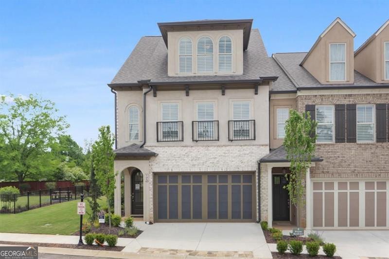 Welcome to this stunning, 2022 built end unit townhome located in the gated community of Tuscany Village, where modern design, comfort, and convenience come together seamlessly. This thoughtfully designed home features 3 spacious bedrooms, 2.5 bathrooms, and a bright, open concept layout that flows effortlessly from the oversized island kitchen into the dining and living areas. The kitchen is a true centerpiece, equipped with a gas cooktop and vent hood, a wall-mounted microwave combo, perfect for both everyday living and entertaining. Upstairs, a curved staircase leads to a cozy loft-style flex space, ideal for a home office, media room, or reading nook. The upper level also includes a large walk-in laundry room with built-in cabinetry, as well as a generous owner's suite featuring dual walk-in closets and a spa-like bath with a freestanding soaking tub, dual vanities, and a walk-in tiled shower. Additional highlights include custom accent walls and detailed millwork throughout, a renovated guest bedroom, and a secondary bedroom fitted with California Closets perfect for someone with a large wardrobe, though easily converted back depending on the buyer's needs. As an end unit, this home also offers added privacy, a fenced and turfed backyard for low maintenance outdoor enjoyment, and convenient proximity to guest parking. Residents will love the low maintenance lifestyle provided by the beautifully landscaped, HOA maintained grounds. Spend time at the dog park, play a game of bocce, relax at the community pavilion, or head out to one of the 69 eateries within a 5 mile radius. Set within the highly rated River Ridge High School district and surrounded by everyday conveniences, this home is ideal to lock and leave, reside and raise, rest and relax, or connect and commute. Tuscany Village offers the perfect balance of accessibility and tranquility, with quick access to Downtown Woodstock, The Outlet Shoppes, major grocers, and local dining favorites. Commuters will appreciate the easy routes to Hwy 575, Peach Pass lanes, and Hwy 400. This is a rare opportunity to own a highly upgraded, move in ready home in one of Woodstock's most desirable gated communities.