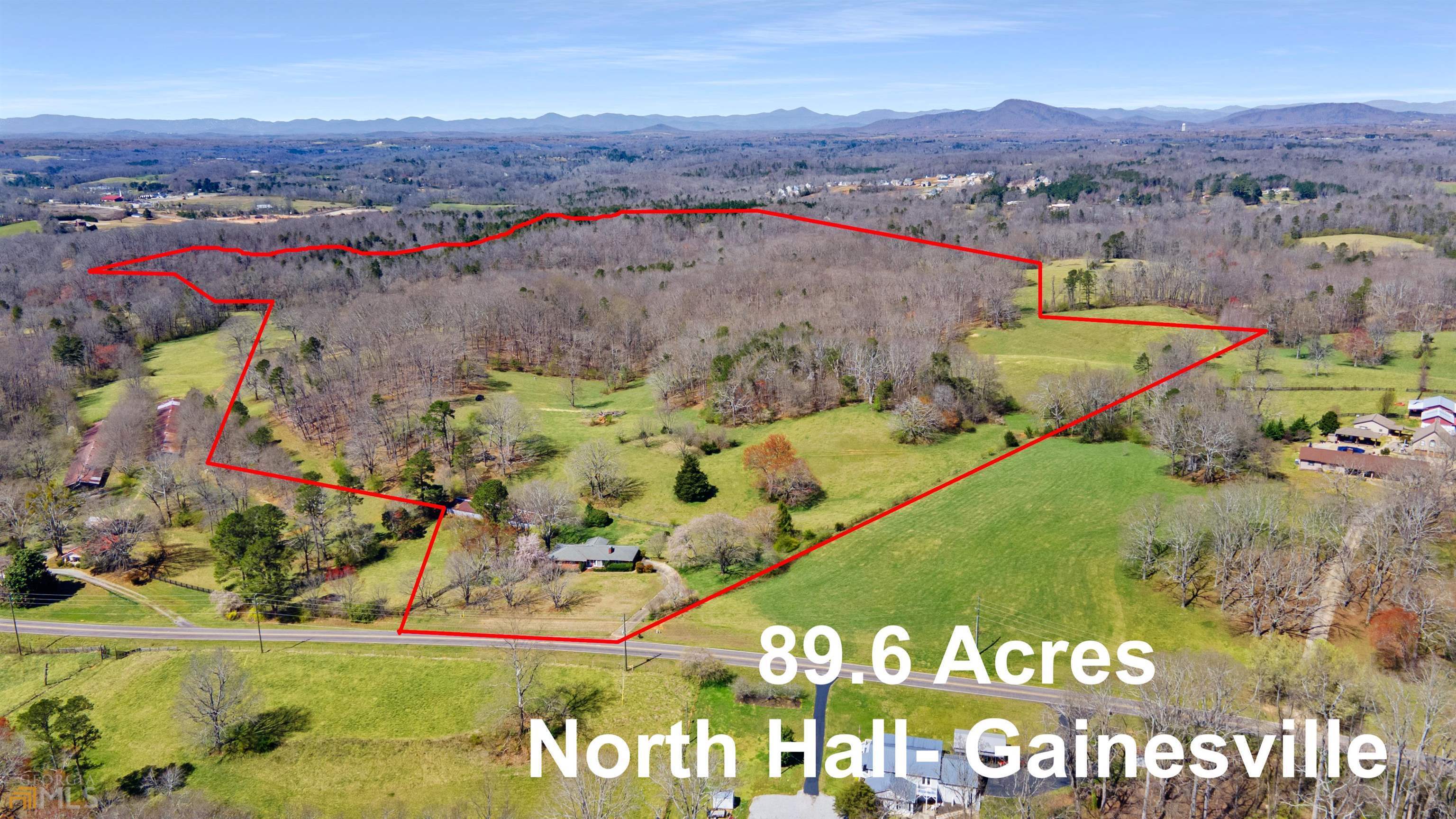 89.6 ACRES - NORTH HALL SCHOOL DISTRICT - GAINESVILLE This is a once in a lifetime opportunity to own a large tract of land in North Hall. Nestled on Honeysuckle Road with quick access to Clarks Bridge, Lanier Olympic Park, Cleveland Hwy, and downtown Gainesville. Plenty of room to build a family compound, hunt, raise livestock, harvest timber, plants crops, or simply enjoy the beauty of North Georgia. Near the front of the property you will find an all brick ranch home with 3 bedrooms 3 baths built in 1979 complete with natural gas, well water, and septic. A separate metal barn sits behind the home to the West. Wire fence runs the majority of the property with a creek lining the West boundaries. Survey updated January 2022.