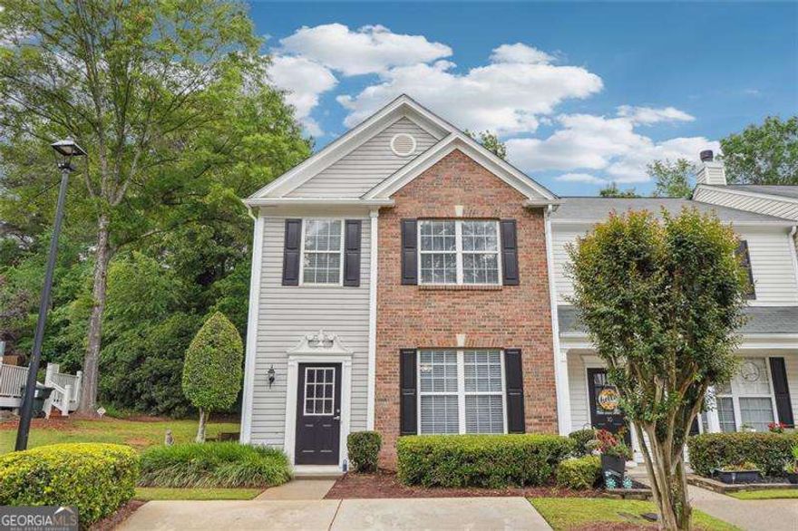 Location! Location! Location! This beautiful updated end unit townhome is in a prime location, easily accessible to Alpharetta, Johns Creek, and Roswell. The main level features an updated kitchen open to the family room, eating area, and half bath all with laminate, hardwood flooring. Upstairs you will find a spacious primary bedroom with a vaulted ceiling and primary bath including a double vanity and walk-in closet. There are also two secondary bedrooms with a  secondary bathroom as well as a laundry closet with washer and dryer. All of the interior was just freshly painted. Outside the back door is a private, relaxing patio and backyard area overlooking a beautiful tree filled wooded area. Roof is less than one year old. Additional visitor parking spots for guests are just a short walk away. No rental restrictions. Great schools! Located just minutes from shopping, parks and recreation, schools, highways, restaurants, and more! FHA approved community.