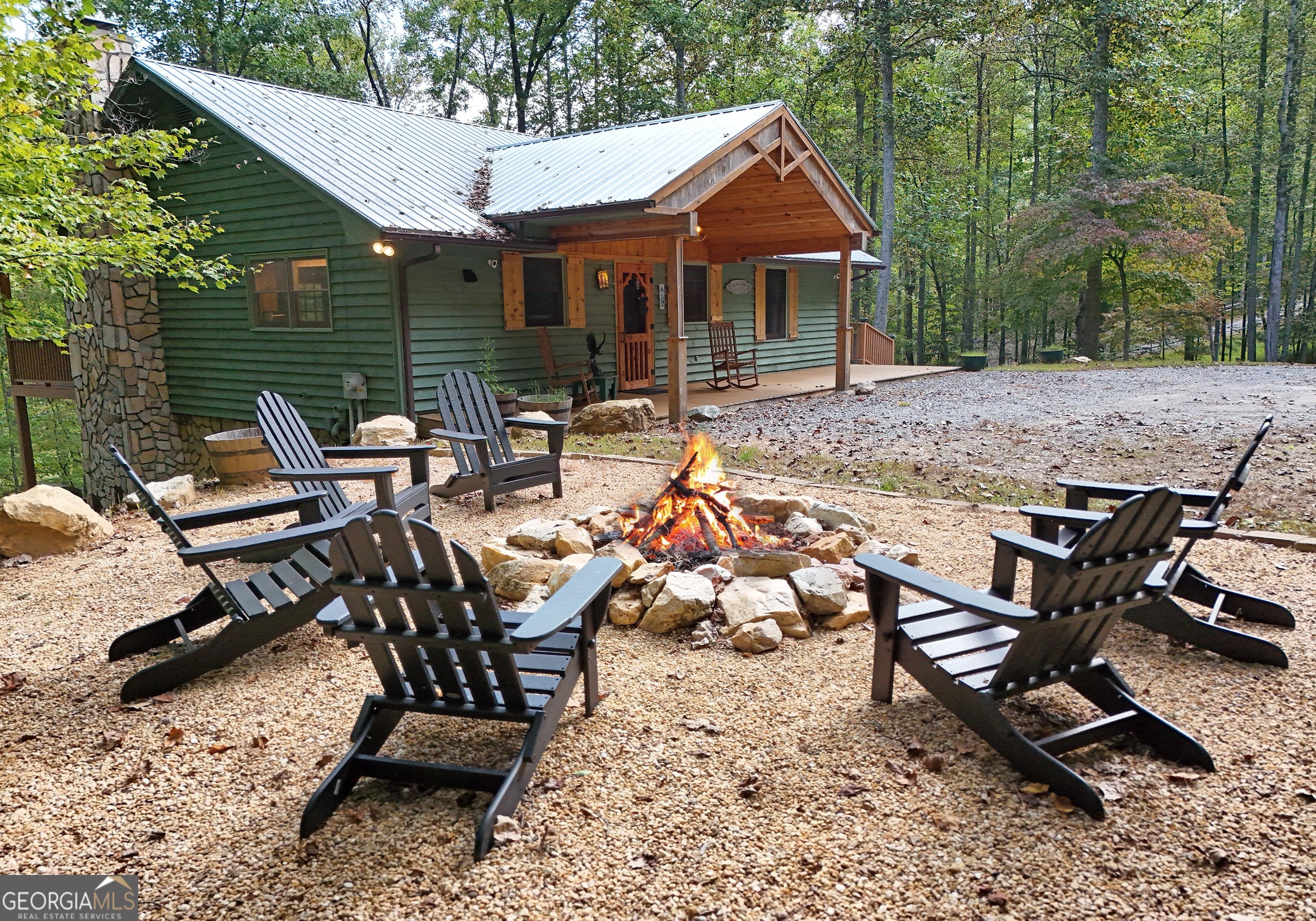 This Spacious 3 Bedroom, 3 Bath Home on 5 Private Acres Captures Seasonal Mountain Views. A peaceful blend of comfort with land to explore! You'll enjoy a warm inviting open living area with cozy masonry fireplace, cathedral ceilings, large family kitchen with granite countertops. These owners have added the new front gabled porch, new timber tech decking, new hvac in 2023, hot water heater in 2021, washer and dryer in 2024, new flooring in the hallway, and the 2 main floor bedrooms, new doors, light fixtures and plumbing fixtures throughout. Remodeled terrace level great/game room, that added wood walls and trim, new laundry area, and luxury vinyl flooring, plus fun games for the kids! Being sold fully furnished, except for a couple items the owner wants. Everything has been well maintained and cared for. Second washer and dryer hookup on main floor if desired. Garage at the lower level. Enjoy the outdoor space with the large, covered decks or relax in the inviting hot tub! Added in 2021 a 1000-gallon cistern water system with UV light filtration system. Enjoyed by this family plus rented out as a short-term rental as well.