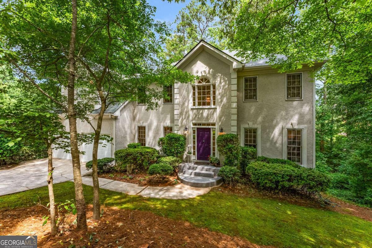 Welcome to your own private sanctuary in one of East Cobb's most sought-after neighborhoods. Tucked away on a serene, wooded lot, this home offers a rare blend of privacy, natural beauty, and community connection. Surrounded by mature trees, gently rolling hills, and winding roads, the neighborhood boasts a warm, welcoming spirit with amenities including a playground, tennis courts, and swimming pool - perfect for those seeking both peace and play. This home offers abundant flexible living space to fit your lifestyle today and grow with your needs tomorrow. The main level welcomes you in to a gracious 2-story foyer with a formal dining room and versatile den or home office. Gather in the heart of the home: the spacious, open, family room that flows into the breakfast area and large kitchen. Pour a glass of wine, from the built-in wet bar, and settle in around the fireplace for warm, cozy, evenings. The spacious laundry room and 2-car garage add everyday convenience and additional storage space. Out back, the multi-level deck offers ample space for grilling, dining al fresco, or hosting memorable gatherings under the trees. Upstairs, the impressive primary suite is a true retreat, with plenty of room for a sitting area, nursery, or Peloton. The en-suite bathroom is airy and light-filled, boasting tall ceilings, a garden tub, separate shower, and dual vanities. Three additional bedrooms share a clever Jack-and-Jill 1.5-bath layout, ensuring both privacy and practicality. The fully finished basement is a dream - whether you need a guest suite, play area, game room, art studio, gym, or home office, this expansive level delivers. It includes a full bathroom, tons of closet/storage space and is stubbed for additional plumbing, ready for a future kitchenette. Step out onto the screened porch and relax into the sights and sounds of your backyard haven. The lush, natural, landscape is a sanctuary for birds and pollinators, and is terraced to help prevent erosion, while celebrating the native landscape - a peaceful haven for both people and wildlife. Having only two owners, this home has been lovingly cared for & meticulously maintained, including a newer water heater (2021), HVAC system (2020), roof (2018), whole-house vacuum system, new refrigerator, and fresh paint on the main level. Located just minutes from restaurants, shops, grocery stores, parks and recreation, entertainment, hospitals, and top-rated schools, this home offers the winning combination of functionality, tranquility and ultra convenience. After 30 years of love and memories, the current owners are ready to pass the torch. Now it's your turn to make this special place your forever home.