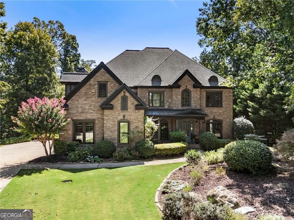 Welcome to this beautifully updated traditional home in Milton's sought-after 'Highland Manor' community. Nestled on a private 1.3+ acre cul-de-sac lot, this property offers both tranquility and convenience, with easy access to top-rated schools, shopping, and dining. Step inside to a stunning two-story foyer flanked by a formal living room/office and an elegant dining room. Recent renovations include: refinished hardwoods, new carpet, fresh paint, and updated lighting. A guest suite with full bath access, plus a separate half bath, makes entertaining easy. The fireside great room boasts a coffered ceiling and custom built-ins, flowing seamlessly into the gourmet kitchen with marble countertops, stainless steel appliances, and freshly painted cabinetry. A sunlit breakfast room and cozy keeping room with stacked-stone fireplace complete the space, along with a walk-in pantry and home management center. Upstairs, retreat to the oversized primary suite with fireside sitting area, built-ins, and dual custom closets. The spa-like primary bath features a soaking tub, separate shower, and abundant space. Three additional ensuite bedrooms, a large bonus room, and a convenient laundry room complete the upper level. The finished terrace level offers incredible versatility, with a fireside living area, gaming space, media room with projector and surround sound, two bedrooms, two full baths, and walk-out access to the private backyard. A second laundry connection adds extra convenience. Additionally, most windows have been replaced. Enjoy Highland Manor's amenities, including a swimming pool, tennis courts, and clubhouse + fitness facility. Located in the highly regarded Cambridge High School district, this home is just minutes from Crabapple, Avalon, Halcyon, Birmingham Village, and Scottsdale Farms, plus local favorites like 7Acre BarnGrill and Matilda's Music Under the Pines.