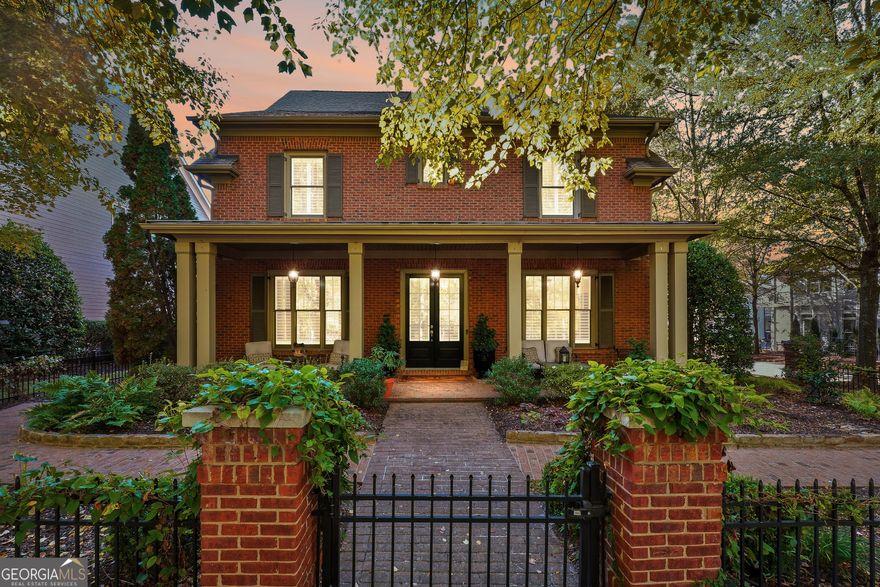 Welcome to this stunning former model home in highly sought-after Crabapple Crossing, just steps from the charming shops and dining of downtown Crabapple. This classic brick traditional shines from the moment you arrive with upgraded details including wide baseboards, custom millwork, and fresh hardwood flooring throughout the main level.    The updated kitchen features quartz countertops, stainless steel appliances, and a custom center island that seamlessly opens to the fireside family room with coffered ceilings and custom built-ins - perfect for everyday living and entertaining alike. A redesigned main-level powder room adds a fresh, modern touch. Plantation shutters throughout provide timeless style and enhanced privacy in every room.    Retreat to a backyard designed for year-round enjoyment with an Italian-inspired atmosphere: an outdoor wood-burning fireplace, water features, brick and stone garden architecture, a retractable lanai cover, and evening uplighting that transforms the space into a beautiful oasis.    Upstairs, you'll find fresh carpet and paint, along with spacious bedrooms and a fully renovated primary bathroom offering a spa-like experience.    Additional upgrades include an epoxy-sealed garage floor along with added storage cabinetry - a clean and organized space for everything.    With HOA-maintained lawn care, you'll have more time to enjoy this incredible lifestyle. All of this just moments from award-winning schools, parks, and the vibrant offerings of downtown Crabapple.