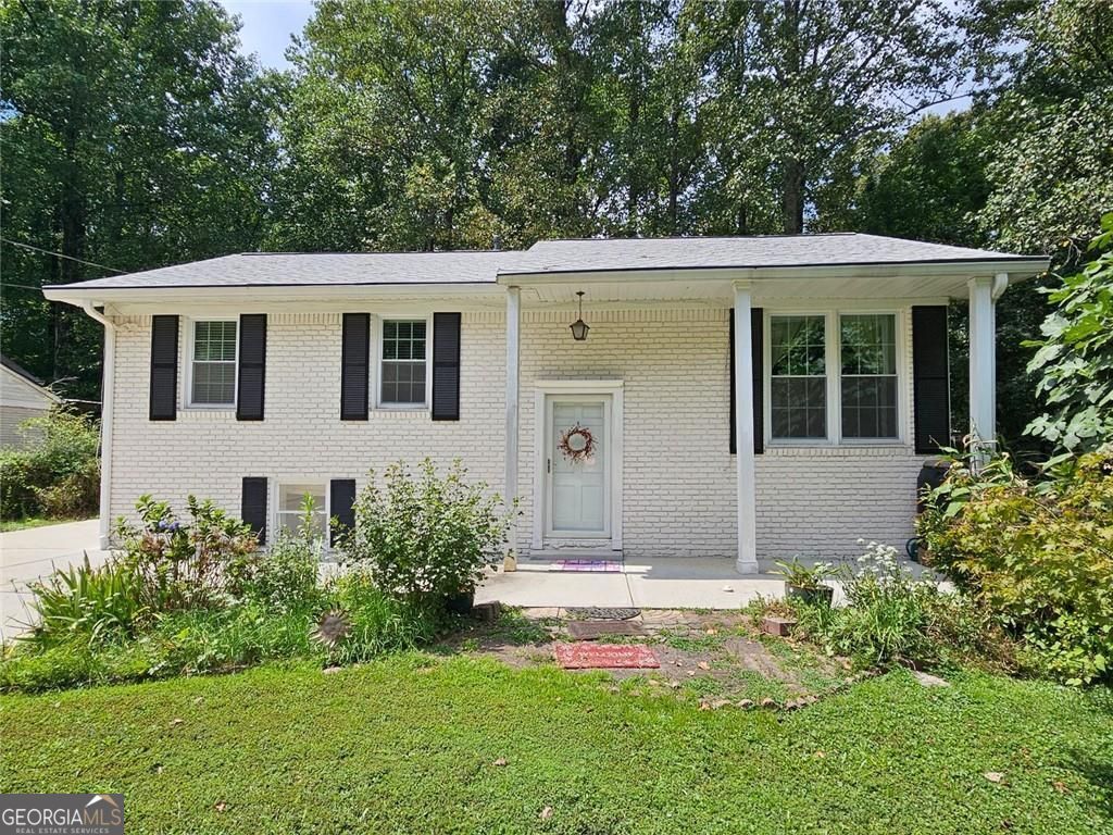 Priced to sell! Move right in and make it your own! This home presents an opportunity to embrace comfortable living in a highly desirable location. The open living area with its original hardwoods is anchored by the updated kitchen featuring a large island with lower cabinet storage and stone countertops. This kitchen is designed to be both functional and aesthetically pleasing while preparing meals and entertaining guests in this stylish and well-appointed space. This property includes four bedrooms and three bathrooms, and can be used as 3 separate living spaces or multi-generational with a second kitchen on the lower level. Alternatively, the open floor plan encourages a sense of togetherness. Enjoy the outdoors from the versatile sunroom, where you can appreciate the tranquil woods view and landscaped yard. Make this your office, bedroom, entertainment space, or additional living area to experience the beauty of nature from the comfort of your own home. Built in 1964, with 2640 square feet of living area, this residence offers a blend of classic charm and modern convenience with abundant possibilities. Enjoy close proximity to everything Perimeter and Downtown Chamblee have to offer. No HOA, voluntary Neighborhood Association, optional swim/tennis club. Huntley Hills Elementary offers a very popular and highly rated Montessori program. Newer roof, HVAC, driveway, sewer line, LVP flooring on lower level