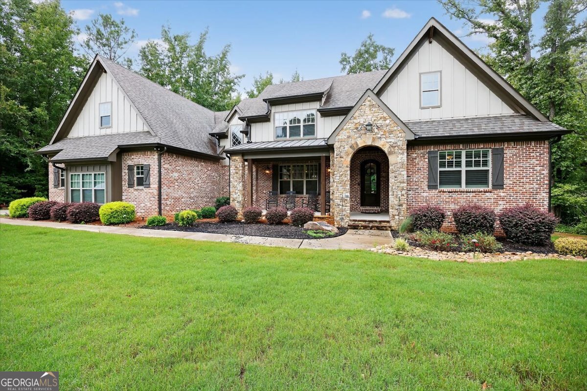 This stunning 4-bedroom, 4.5-bath home on 1.3 acres offers the perfect blend of style, space, and functionality. The inviting front porch sets the tone, welcoming you into an open floor plan designed for both entertaining and everyday living. The heart of the home is the beautiful kitchen, featuring a large island overlooking the eat-in area and spacious great room. A screened porch and deck extend your living space outdoors, ideal for morning coffee or evening gatherings while enjoying the private backyard. The main level hosts a luxurious master suite with spa-like bath, plus a guest bedroom and full bath-perfect for visitors or multi-generational living. Upstairs, you'll find additional bedrooms, baths, and a bonus room while the unfinished basement offers endless potential for future expansion. With exceptional curb appeal, thoughtful layout, and a serene setting, this home is truly a rare find. Located in River Forest- a gated golf, tennis, & pickleball community. 45 minutes South of Atlanta & 30 minutes North of Macon.