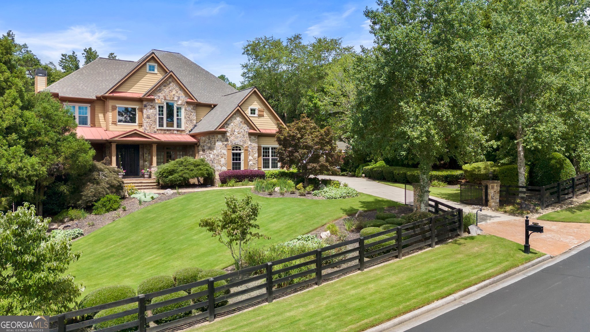 Don't miss this immaculate home in Canterbury on the Lake, it is truly spectacular. Located in the heart of Milton, this lake community of executive estates with gated driveways and lushly landscaped yards invites you home to luxury. At 15745 Canterbury Chase, you will find a beautifully updated interior with walls of windows overlooking a perfectly groomed backyard that truly has it all - pool, hot tub, a natural water features, annual and perennial gardens, a fully furnished pool house, and a grassy lawn that extends to the back of the one-acre lot. Don't miss the side flagstone shade patio perfect for grilling and sipping a coffee or a cocktail. The property's structures and systems are well-maintained, paint is fresh, and the bedroom carpet is NEW (2024). Floor to ceiling windows span the entire length of the back of the home, be them in the living room or the sunroom, to enjoy the stunning private backyard view. The sunroom has LVT flooring, a separate Bose sound system and remote-control blinds for convenient operation and unobstructed views. The sunroom opens to the family room with built-in's and a stacked-stone gas fireplace and the updated kitchen, with quartzite counters, white cabinets and stainless steel appliances. The foyer is planked by a designated office with french doors and covered front-porch access, and a dining room made for entertaining. Architectural detail is everywhere, from the iron front doors to the extensive millwork. This sizable home has four bedrooms up, each with en-suite bathrooms and an oversized master with a spacious sitting area, gas fireplace and backyard views. A fifth bedroom and bath are on the terrace level, with a TV room, full bar, exercise room and workshop, tile floors, and large picture windows overlooking the covered lower patio and pool. Pause by the saltwater Pebble Tec heated pool and hot tub. Enjoy the stone creek and waterfall feature. Have a seat in the pool house with wood-burning fireplace, bar, TV and sofa-seating area, half bath, Bose surround-sound system and retractable curtain screen to retain heat for those football game days. Windows are all NEW double-pane vinyl for maximum energy efficiencies (2021). The home has Ring doorbell and a garage alarm both with cameras for enhanced security. The three HVAC systems are NEW (2023), the roof is NEW (2022) and the Navien tankless water heater with InstaHot re-circulate was installed in 2020. This executive estate property is move-in ready! Enjoy luxury country living with nearby grocery, retail, dining and professional services, where schools are highly acclaimed and Alpharetta's downtown city center and the Crabapple Market District are easily accessible.