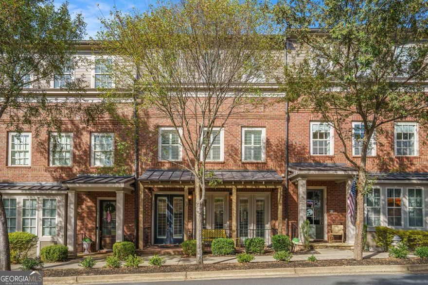 Step into a luxurious lifestyle in this four-story, elevator-equipped townhome in Meeting Park - one of Marietta's premier communities - just steps from Historic Marietta Square.  Entering the home's main level you find 10' ceilings, new hardwood floors (with a no fee transferable lifetime warranty), and plantation shutters throughout.  Relax on the front porch, or gather in the fireside living room which is adjacent to the dining area.  At the heart of this open concept level is the chef's kitchen which seamlessly connects the living/dining areas with a bright sunroom.  Across from the kitchen you step out onto the rear veranda.  An updated half bathroom completes this level.   Take the convenient elevator or the stairs to the third floor's primary suite with its crown moulding, large custom walk-in closet (with built-in safe), and large bath featuring a freestanding tub and frameless shower.  Also on this level is a second bedroom with ensuite bath and the laundry room with its new LG washer and dryer.  The hardwood flooring and plantation shutters continue throughout the third and fourth floors.  The fourth level highlights another large bedroom, ensuite bath, and large living space which is ideal as a guest suite or entertainment area.  This level is completed with a rooftop deck that offers panoramic views of downtown Marietta and Kennesaw Mountain.  An ideal space for watching sunsets, fireworks and other gatherings.  On the terrace level you find a mudroom drop zone across from the elevator which makes it easy to organize groceries, bags and other daily essentials.  Here also is a large bonus room with custom built-in storage, vibrant mural and full bath - a great guest suite, gym, office or playroom.  The two car garage features epoxied floors and an abundance of overhead storage.  The Meeting Park community offers amenities including a pool, dog park, pocket parks, fire pits and plenty of guest parking.  The list of updates to this home is long but primary among them are two Lennox high efficiency HVAC units installed in February 2025 with a no fee transferrable warranty, hardwood flooring and new lighting throughout.  This luxury home has been upgraded, meticulously maintained and provides the convenience of move-in ready for discerning Buyers who appreciate the close by amenities found in Marietta Square such as shops, restaurants, wine bars, museums, trails, and numerous year around events (with the added convenience of no parking hassles!)