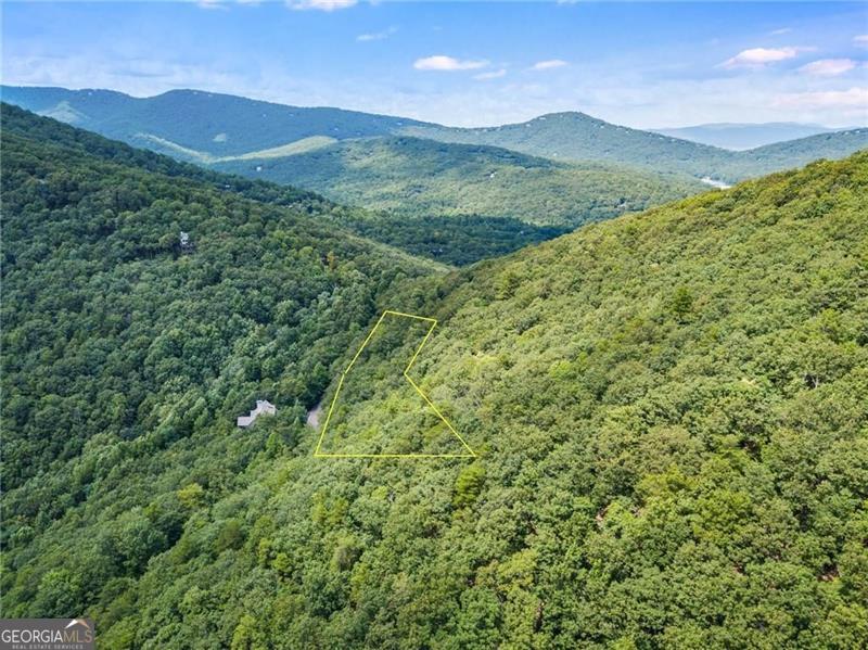 Come and enjoy all that Big Canoe has to offer! This attractively priced homesite is located on very prestigious Cox Mountain which is centrally located near the Wolfscratch Village where Big Canoe's award winning amenities are based, and yet less than 5 minutes from the Main Gate for your convenience. This estate parcel is 1.86 Acre in size and would be an uphill build that will provide stunning long range panoramic mountain views once the home is built. This is a gorgeous lot with lush hardwood trees throughout, and an excellent value.