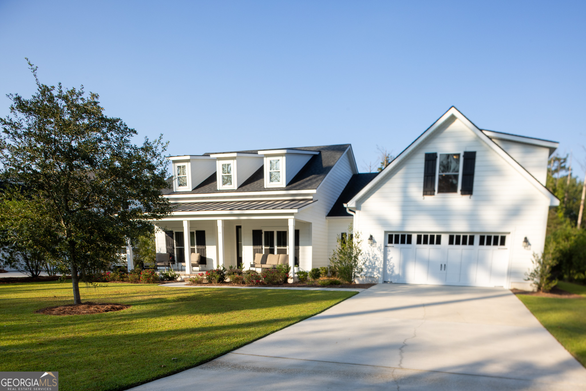 Welcome to this stunning modern farmhouse in the gated community of The Woods. Built in 2019, this 4-bedroom, 3 full bath home with 2,700 sq. ft. blends open-concept living with timeless design and thoughtful upgrades. Step inside to 9-foot ceilings, hardwood floors, and bright open living spaces filled with natural light. The heart of the home is the open kitchen and living area, featuring granite countertops, a spacious island with seating, stainless steel appliances, a farmhouse-style sink, and a walk-in pantry with sliding barn door. The living room centers around a cozy gas fireplace and flows seamlessly into the dining area and a flexible extension of the main living space that is perfect as a sitting area, playroom, or reading nook. The primary suite offers a spa-like retreat with a freestanding soaking tub, walk-in shower, double vanities with Jack and Jill sinks, and a walk-in closet directly off the bathroom. Three additional bedrooms and two additional full bathrooms provide plenty of room for family and guests. A standout feature of this home is the finished bonus room above the garage, complete with its own bathroom and individual thermostatic climate control- perfect for a guest suite, home office, media room, or private retreat. The dedicated laundry room includes built-in cabinets, a sink, and extra storage. Outside, enjoy the covered back patio overlooking a fenced backyard, peaceful retention pond, and wooded backdrop, ideal for entertaining, pets, or simply unwinding in privacy. The .35-acre lot is beautifully landscaped with a wide driveway and spacious finished two-car garage with extra storage. Located in the Bryan County school district, this move-in ready home offers comfort, space, and convenience with quick access to Richmond Hill, Fort Stewart, Hunter Army Airfield, Savannah, and I-95.