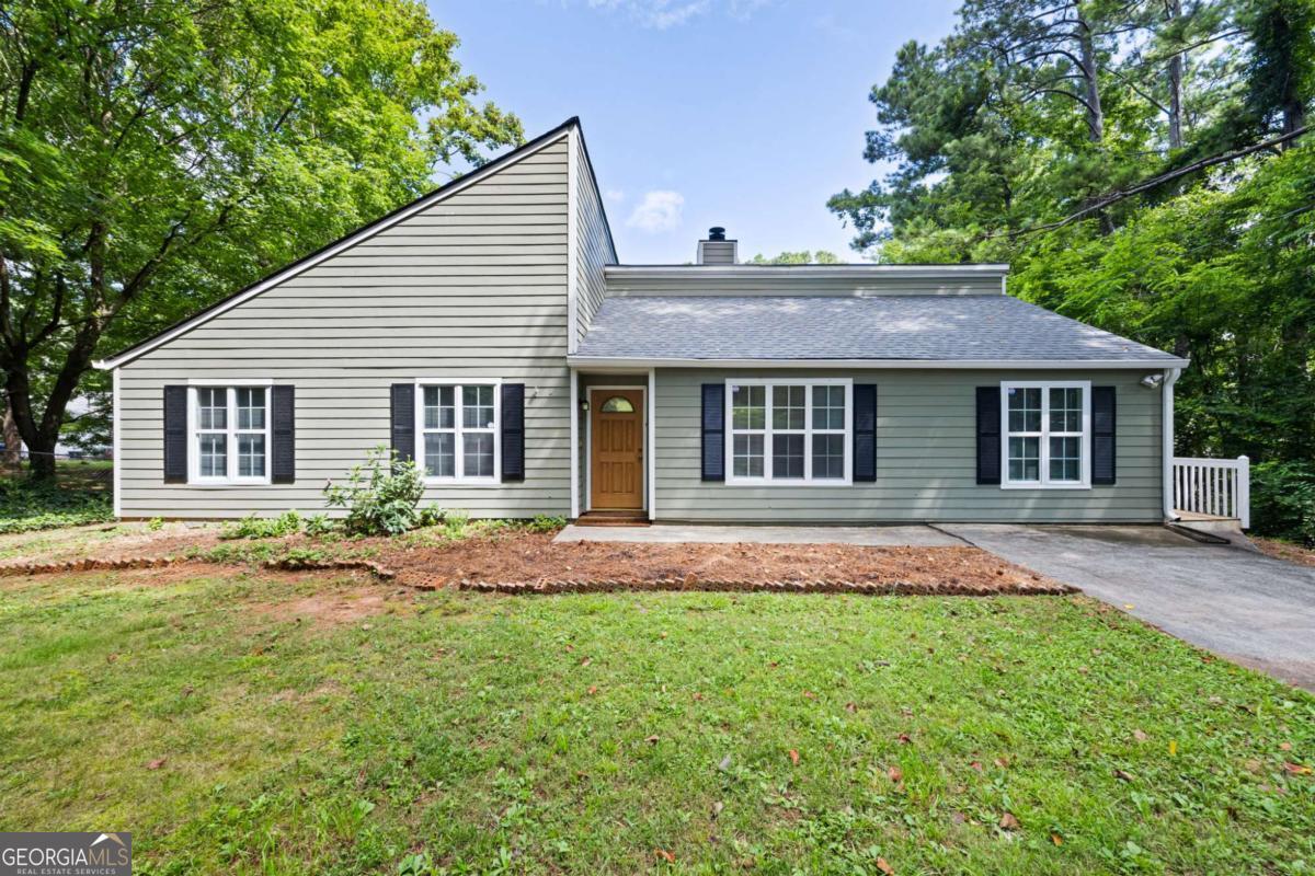A beautifully maintained 3 bed, 2 bath home tucked into a quiet cul-de-sac with no HOA. Inside, you'll be greeted by a cozy stone fireplace that anchors the family room and stylish vinyl plank flooring. The bright white kitchen has ample cabinets, granite countertops, a gas stove and bar seating along with a spacious eat in dining space. The bedrooms are spacious and have new carpet. Step outside to a large deck overlooking a fantastic fenced backyard - perfect for entertaining, gardening, or pets. There is a shed in the back as well as a storage room on the side of the house. With its spacious layout and unbeatable outdoor space, this home is a standout just minutes from shopping, dining, 575 and downtown Woodstock. Seller financing can be arranged.