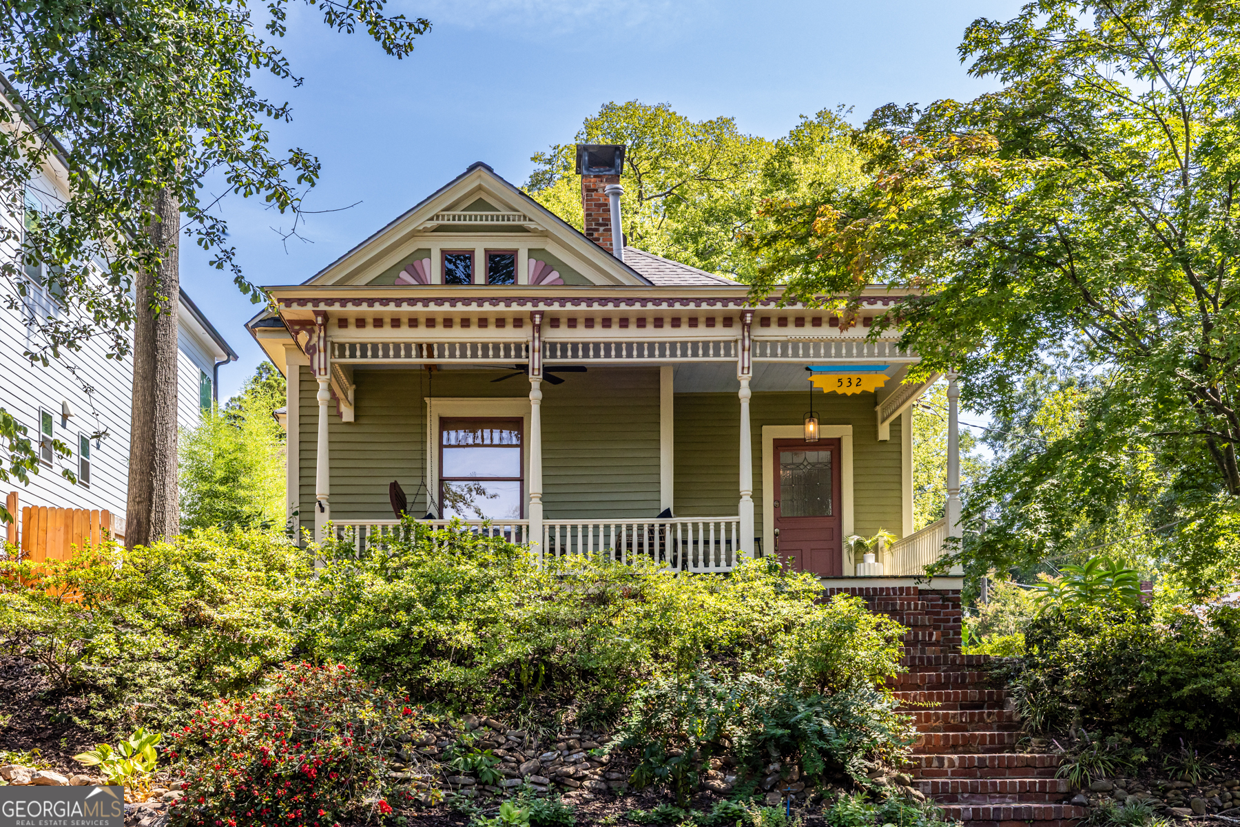Dream Location in Historic Grant Park Nestled in the heart of Grant Park, this charming 1920s Victorian bungalow offers the perfect blend of timeless character and modern updates. Perched high on a landscaped, private lot, the home enjoys wonderful views?including glimpses of downtown?and a storybook front porch that welcomes you in. Inside, the main level features two bedrooms and two full bathrooms. The spacious primary suite boasts an updated bathroom with a walk-in shower, frameless glass, and abundant natural light. A second renovated bathroom complements the additional bedroom. Living and entertaining are easy with a stylish kitchen, dining room, and inviting living room that showcase the home?s classic details. Upstairs, a hardwood-floored bedroom with a full bath provides excellent flex space?perfect for in-laws, guests, or a home office. The location is truly a 10/10: just steps from Summerhill, Grant Park, neighborhood schools, and with quick access to I-20, downtown, and everything Atlanta has to offer. A low-maintenance yard, garage slip at the back, and years of loving care make this home as practical as it is beautiful.