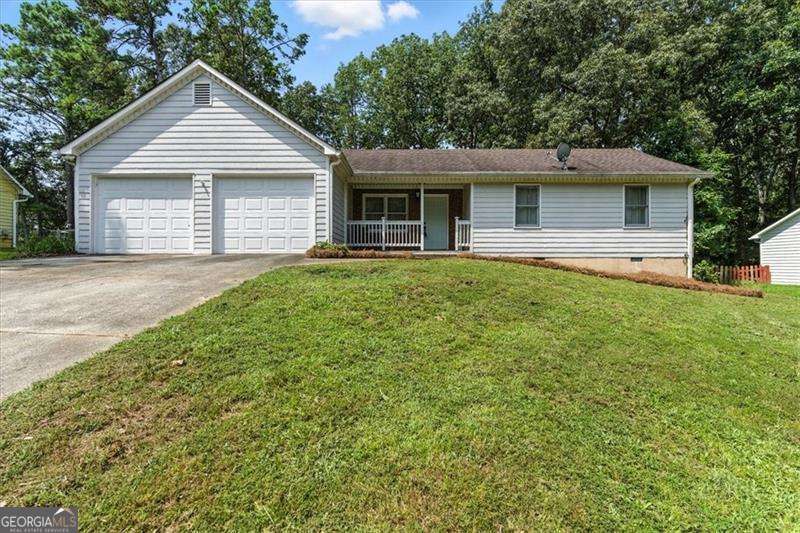Renovated raised ranch on .51 acre: 3 beds, 2baths. Kitchen/dining have new LVP flooring. Kitchen features stainless appliances, granite, new cabinets and island; double doors open to large new deck and patio-ideal for entertaining. Vaulted ceilings in family/dining rooms with fireplace and hardwood floors elsewhere. One-level layout suits down-sizers or first-time buyers. Level wooded yard, fenced, with attached 2-car garage. Walk or drive to vibrant Downtown Woodstock, featuring the amphitheater, trendy shops and restaurants. Access the Greenprints Trail along Noonday Creek to Woodstock Dog Park and Towne Lake. Close to Blankets Creek, Hobgood Park and Lake Allatoona. Zoned Boston Elementary, E.T. Booth Middle and Etowah High.