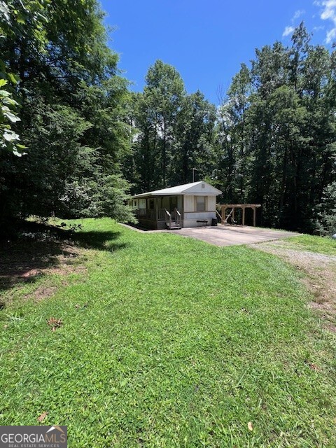 Location is King! 2BR/1BA mobile for sale in City Limits of Dawsonville on over 1.5 acres with small branch in backyard. Ownership is cheaper than paying rent. Perfect for investment second home or permanent home. Older mobile, but in very good condition. Home for less than $150,000! What an opportunity!!