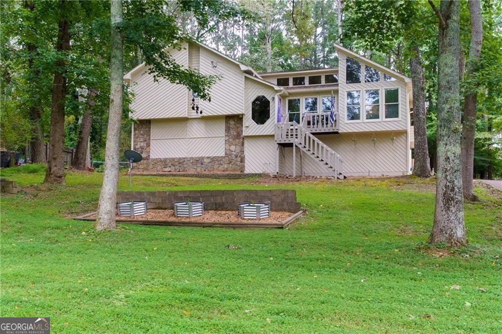 Welcome Home to 314 Bethel Drive Where Comfort Meets Community! Tucked away in a friendly swim/tennis neighborhood, this charming Woodstock home offers the perfect mix of space, warmth, and convenience. Just a short drive/golf cart drive to Lake Allatoona, Sunset Grille, Victoria Marina, JD's on the Lake, and Little River Marina-you'll love being so close to the water, dining, and fun! Step inside to an open, airy floor plan with a vaulted family room that feels bright and welcoming. The updated kitchen flows right into the dining room, making it easy to gather with family and friends. With 4 spacious bedrooms and 3 full bathrooms, there's room for everyone to feel right at home. Outside, the multi-level back deck is perfect for summer cookouts or quiet mornings with coffee. The fenced backyard gives you privacy and plenty of space to play, garden, or just relax. There's even a workshop and a bar area in the garage-ideal for weekend projects or hosting game day. From the friendly neighbors to the unbeatable Woodstock location, 314 Bethel Drive is more than just a house-it's a place to call home.