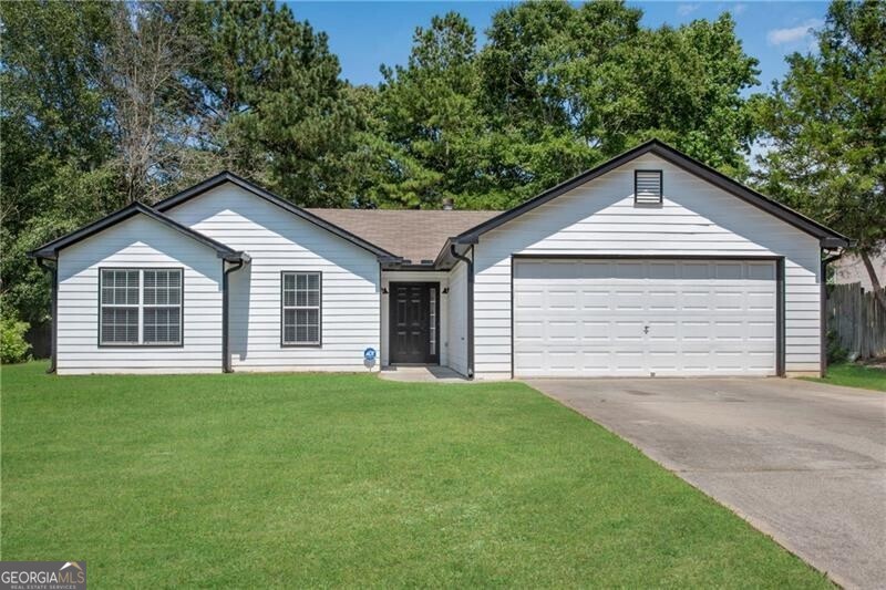 Modern Updated Ranch on private wooded lot! Luxury Vinyl flooring throughout - NO CARPET!! Soaring vaulted great room w/beamed ceiling, recessed lighting and wood burning fireplace has access to the rear patio. The white eat-in kitchen boasts high end veined quartz counter tops, tile backsplash, updated 42" cabinets, SS appliances including a built-in microwave and side by side fridge. Modern black door hardware and faucets through-out. Primary suite w/tray ceiling, walk-in closet, double vanity, soaking tub and separate shower w/glass doors. ALL bedrooms feature ceiling fans. 2" blinds through-out.