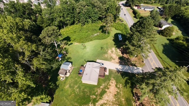 Discover incredible potential with this versatile A1-zoned property, perfectly positioned just 1 mile from the newly approved 24-hour QT gas station at the corner of Jot Em Down Rd and GA-400 in growing Forsyth County. With exciting development already on the horizon, this land offers strong future commercial possibilities. Home currently situate on the property comprised of 3 bedrooms and two bathrooms with a great open concept floorplan, family room and well equiped kitchen. Whether you're a first time homebuyer looking for land, a builder looking to subdivide and develop multiple homes, or an investor seeking a turn-key rental property to add to your portfolio, this opportunity checks all the boxes. Nestled in a desirable and rapidly developing area, this property blends immediate functionality with long-term growth potential. Close proximity to the North GA Outlet Mall. Don't miss your chance to invest in a piece of Forsyth County's future!