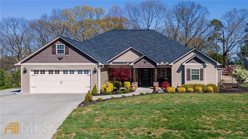 Located just a few miles from Interstate 75 is a one-story craftsman style ranch perched on a hill overlooking a generous pond in Willow Grove. This 3-bedroom, 2-bathroom home offers beautiful natural hues and generous indoor and outdoor entertaining spaces. The interior features vaulted and trey ceilings, walk-in closets, custom soft close cabinetry and so much more! The vaulted family room features a stacked rock fireplace with gas logs and open to the kitchen. Ample cabinetry, walk-in pantry, and a center island create a desirable kitchen. Access to the rear screened porch is located off the eat-in kitchen. The owner's suite features a spa-like bath with a walk-in tile shower, separate makeup vanity and double sinks. A detached garage/workshop is wired for 220 and is serviced by a mini split for heat and air! Several fruit trees are located on the grounds and the property adjoins a fenced pasture. Must See!