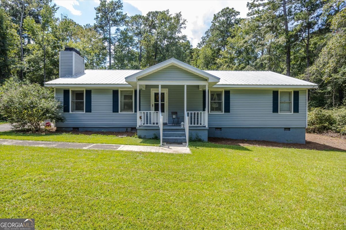Situated on just over half an acre, this spacious three-bedroom, two-bath home features hardwood floors throughout, a screened-in porch, a deck, a metal roof, and vinyl siding. This home is a wonderful place to make memories. Schedule your showing now!