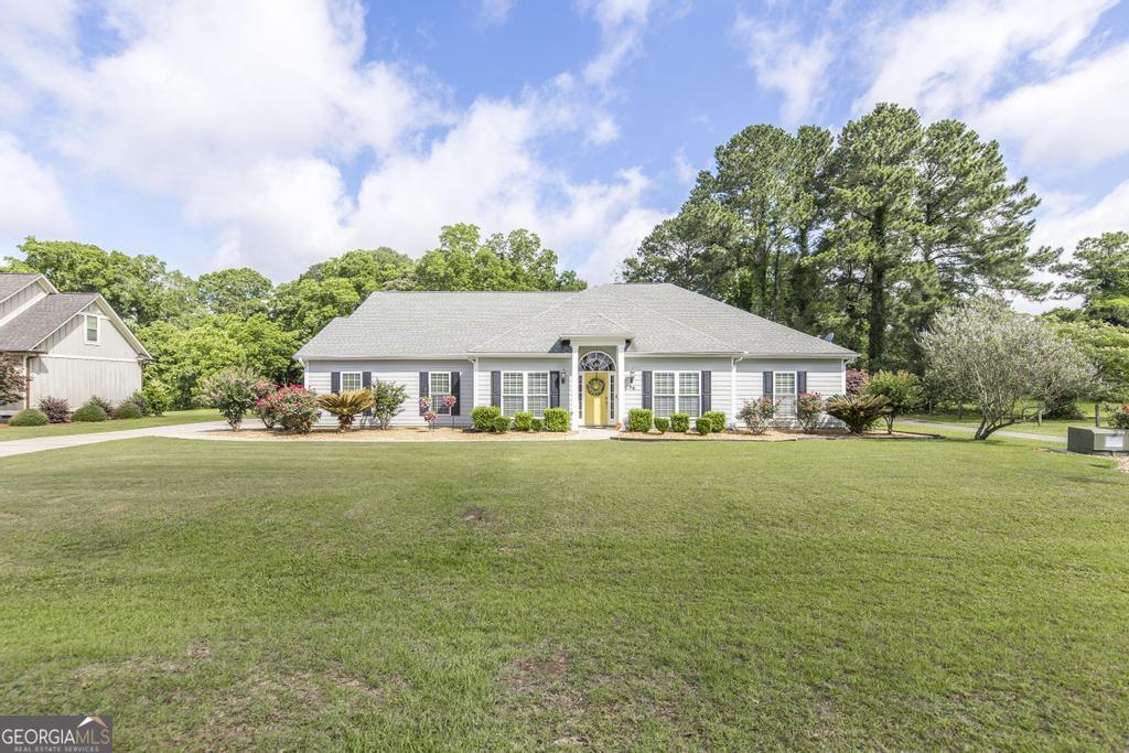 Welcome to 56 Aberdeen Circle, a stunning home located in the prestigious Highland Grange Subdivision, within the Pine Hills golf course. *Just minutes from Lake Blackshear. This exquisite 4-bedroom, 3-bath home offers 3,236 square feet of luxurious living space. Inside, you'll find spacious rooms with elegant finishes, perfect for both relaxing and entertaining. Enjoy breathtaking views of the golf course right from your backyard. This property boasts elegant engineered hardwood floors & LVP, creating a warm and inviting atmosphere. The living room features built-in bookshelf, perfect for displaying your favorite books and decor. You'll love the brand-new tile showers in the bathrooms, adding a modern touch to your daily routine. The oversized primary suite includes a large walk-in closet, offering ample storage space. Additionally, the property includes an added garage with a convenient cook pad, perfect for outdoor entertaining. Plus, there's a bonus room upstairs that can be used as a home office, playroom, or guest space.Don't miss the opportunity to own this beautiful home! Seller now offering a 1 year home warranty upon closing.