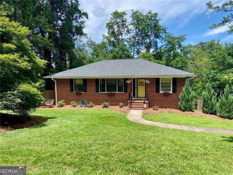 Welcome to 406 S Hillcrest Drive in Whitlock Heights - Just Steps from the Marietta Square! Celebrate the 4th of July by walking to The Square from your new home! This rare 4-sided brick ranch is located in the heart of Historic Marietta and features 3 bedrooms, 2 full bathrooms, and a fully finished basement-offering more space than meets the eye. You'll love the original hardwood floors throughout the main level and the peaceful setting of this quiet, tree-lined street. Start your mornings with coffee on the charming front porch, complete with scenic views of the Marietta City Club Golf Course. The finished basement includes all tile flooring, a renovated full bathroom, spacious 3rd bedroom, laundry room, and a large living or recreation space-perfect for a home office, playroom, or media area. Other highlights include: Ample storage with a large attic and 1-car garage Walkable location near shops, dining, parks, and community events Timeless charm with thoughtful updates and room to personalize This home is a true hidden gem and an absolute must-see-don't miss your chance to own a piece of Marietta's history just minutes from The Square!