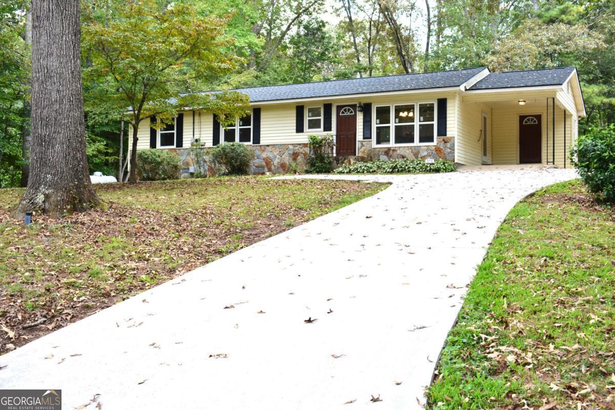 Beautifully updated and move-in ready, this 2-bedroom, 2-bath home combines modern upgrades with timeless charm in the heart of Tallapoosa. The home features a large remodeled primary suite with a spacious bath offering a reglazed one-piece tub/shower combo, double vanity, linen closet, and both standard and walk-in closets. Throughout the home, you'll find durable, low-maintenance flooring with refinished hardwoods in the dining room, hallway, and second bedroom, tile in the secondary bath, and waterproof LVP in the remainder of the home-no carpet or roll vinyl here. The open kitchen includes a bar seating area, new range, and dishwasher, and flows seamlessly into the oversized dining area-ideal for gatherings. Major improvements provide peace of mind, including new architectural asphalt shingles, argon-filled double-pane windows, and modern finishes throughout. The property also offers excellent storage with a heated/cooled utility room on the carport. metal storage building in back that includes garage space, a lockable shelved storage/work room, and full electrical with lights and outlets. Located in charming Tallapoosa, you'll enjoy a quiet community feel while being close to shopping, dining, and local parks. A rare find with so many thoughtful upgrades already complete! Make a great deal even better with Massive savings through special loan programs with the Preferred Lender Envoy Mortgage with Aubrey Wilcox! Ask the Listing Team for the introduction for up to 100% Financing or even interest rates in the 4s!