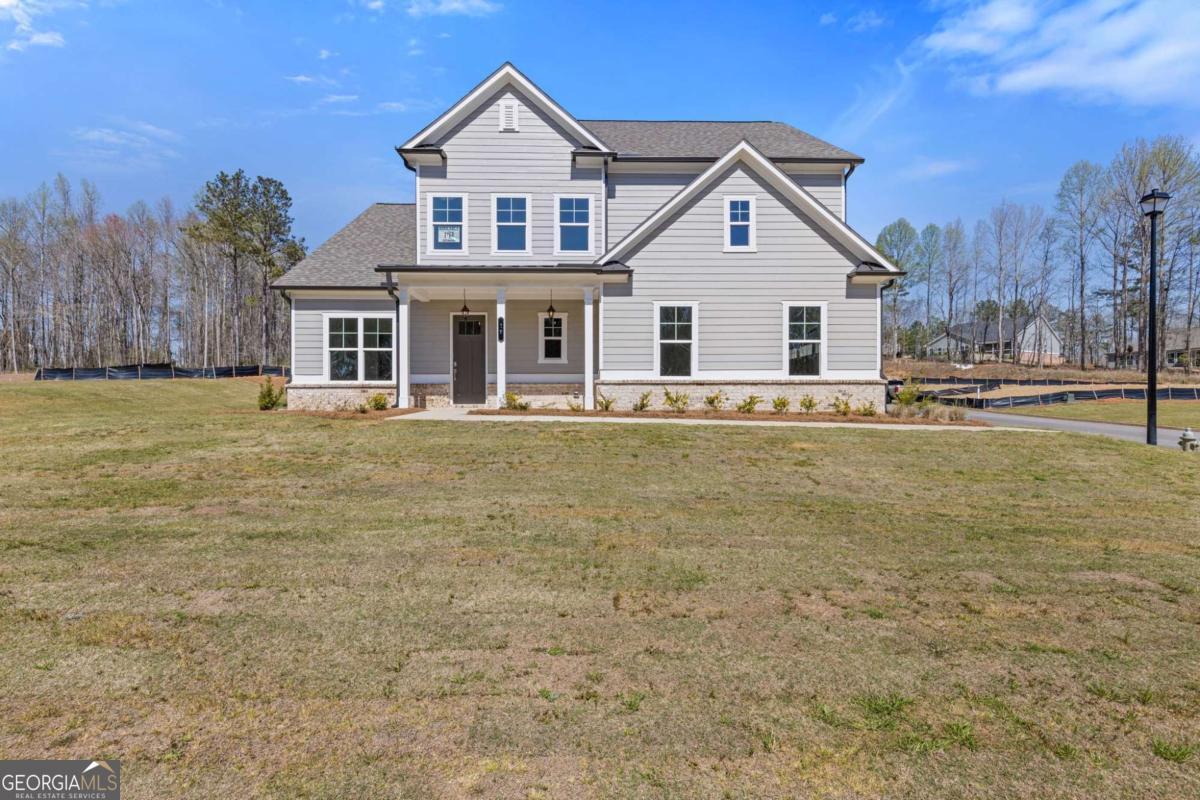 Welcome to 15 Overview Court, Jefferson, GA 30549 - a beautifully designed Jamestown plan situated in the prestigious Traditions of Braselton community. This spacious home offers five bedrooms and four full bathrooms with an open and thoughtfully crafted layout ideal for modern living. The main level features a gourmet kitchen with granite countertops, stainless steel appliances, a large island, and a walk-in pantry that opens to a bright breakfast area and cozy fireside family room. A versatile main-level bedroom and full bath provide a perfect space for guests or a private office. Upstairs, the expansive primary suite offers a serene retreat with a sitting area, oversized walk-in closet, and a spa-inspired bathroom with dual vanities, a soaking tub, and a separate mega shower. Three additional bedrooms and two full baths complete the upper level. Enjoy outdoor living on the covered patio overlooking a peaceful backyard. Residents of Traditions of Braselton enjoy exceptional amenities including an Olympic-sized pool with water slide, clubhouse, fitness center, tennis and pickleball courts, walking trails, and an 18-hole golf course in one of Jackson County's most sought-after communities.