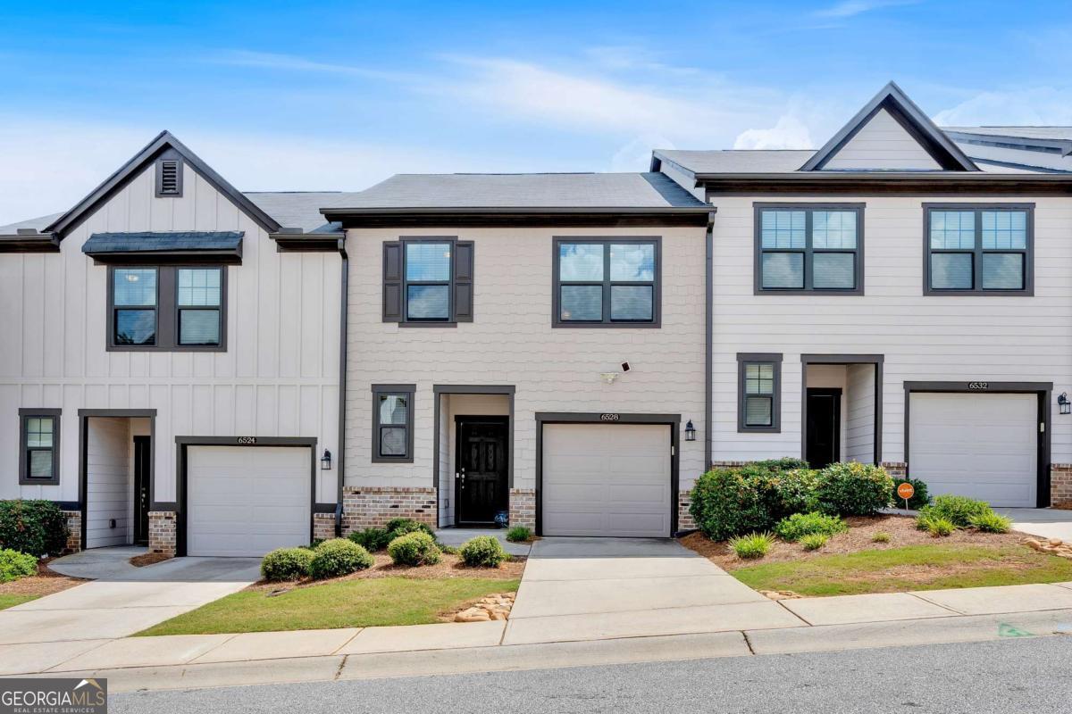 Welcome to this beautifully designed 3 bedrooms, 2.5 bath townhome by Ashton Woods, nestled in the quiet and highly sought-after community of Overlook at Queens Creek in Mableton. Step inside to a bright and inviting foyer that opens into a spacious, open-concept main level featuring 9-foot ceilings and an abundance of natural light. The modern kitchen is a chef's delight, showcasing granite countertops, a generous 5-foot island with additional storage, a walk-in pantry, and stainless-steel appliances. A dedicated dining area flows seamlessly into the warm and welcoming family room, which leads to a private patio, complete with privacy walls, ideal for relaxing or entertaining. A stylish powder room completes the main floor. Upstairs, the serene owner's suite offers a peaceful retreat with a luxurious en-suite bathroom and a spacious walk-in closet. Two additional bedrooms share a full bathroom, perfect for guests, a home office, or a growing family. The upper level also features 2" blinds throughout and plenty of storage options. Whether you're relaxing on the patio or enjoying cozy evenings indoors, this townhome perfectly blends modern style with everyday comfort. Ideally located with quick access to I-20 and I-285, you're just minutes from Six Flags Over Georgia, Truist Park/The Battery Atlanta, Smyrna Market Village, Atlanta Airport, and a wide variety of shopping, dining, and entertainment destinations. Enjoy the convenience of ample guest parking and easy access to the community pool, and cabana with just a short walk away. Rental allowed (Units must be rented in their entirety and for at least 12 months, NO Airbnb). Don't miss this rare opportunity. schedule your private tour today!
