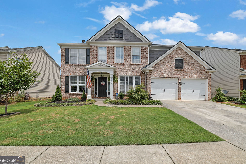 Welcome home to this beautifully updated 4-bedroom, 2.5-bath home in the sought-after Woodland subdivision-just 15 minutes from vibrant Downtown Woodstock and located in the highly rated River Ridge High School district. From the moment you arrive, you'll notice the charming curb appeal with a manicured front lawn and an inviting rocking chair front porch. Inside, you're greeted by a two-story foyer flanked by a formal dining room and a versatile flex space-perfect for a home office or additional living area. The heart of the home is the stunning two-story family room with a cozy fireplace, open to a completely renovated kitchen featuring white cabinetry, granite countertops, tile backsplash, stainless steel appliances, a center island, and a bright eat-in breakfast area. A convenient butler's pantry makes entertaining seamless. The main level is filled with natural light and thoughtfully designed with comfort and functionality in mind. Head upstairs via the back staircase to find four spacious bedrooms, each offering generous closet space. The oversized primary suite boasts tray ceilings and a luxurious en suite bath with dual vanities, a soaking tub, tile shower, and a massive walk-in closet. Step outside to your private backyard oasis with a lush garden, ample green space, and a patio perfect for entertaining, pets, or play. Ideally located near major highways, shopping, dining, and parks, this home also offers access to a rich array of community amenities, including pickleball and tennis courts, a pool, playground, walking trails, and more. Don't miss this move-in ready gem-schedule your private showing today!