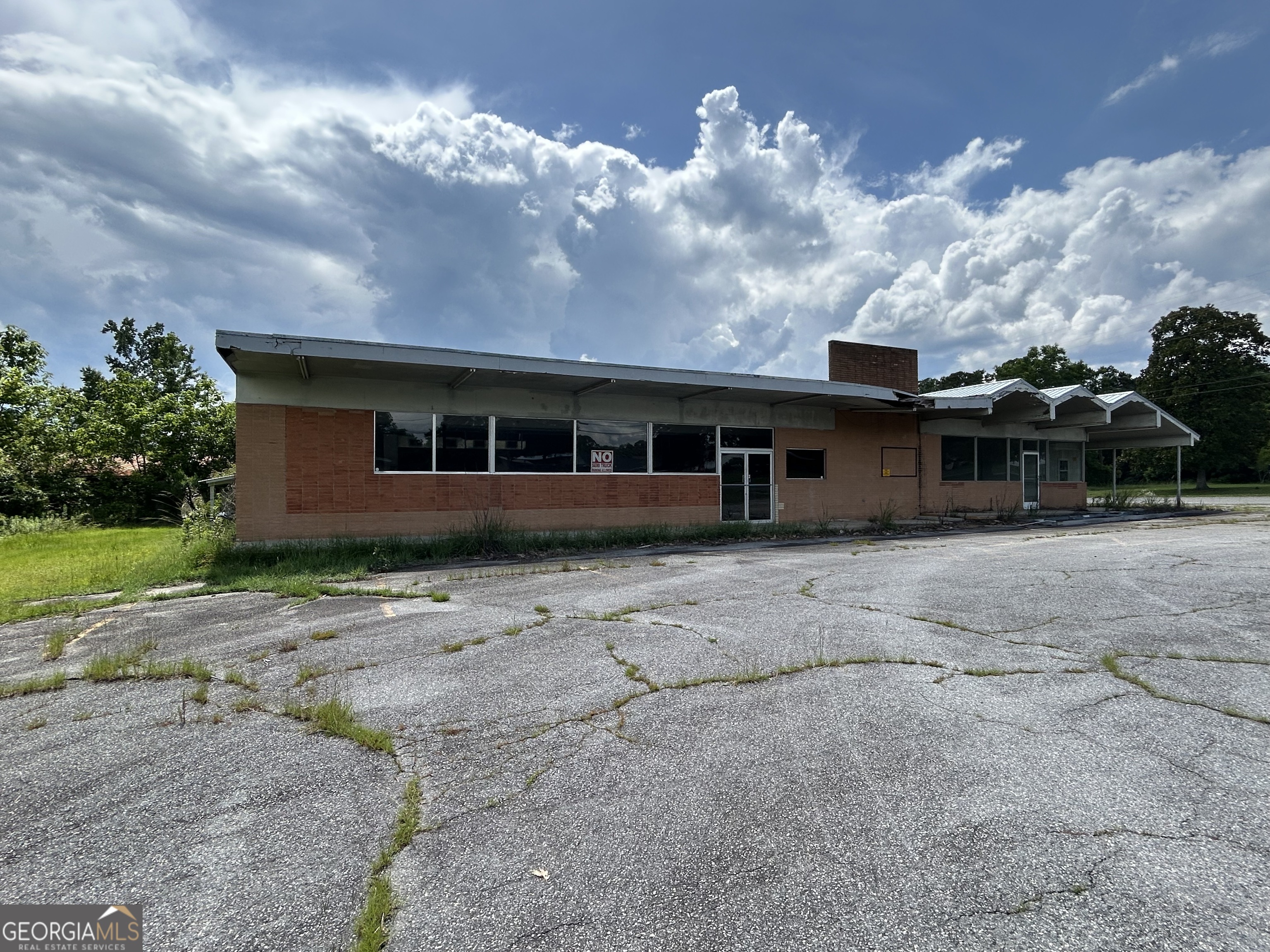 Prime Commercial Property with Endless Possibilities! Welcome to a remarkable opportunity in the heart of Milan! This expansive commercial property boasts an impressive 4,006 square feet situated on a generous .84 acres, providing ample space for various business ventures. Whether you're looking to expand your existing enterprise or embark on a new venture with endless storage possibilities, this property is perfectly positioned for success. Key Features: Spacious Interior: With over 4,000 square feet, the layout is designed to accommodate a diverse range of businesses-from retail stores to offices, and everything in between. The open floor plan allows for flexible configurations to suit your specific needs. This is one building split into two separate spaces. One is 2,240 square feet and the other is 1,766 square feet. Totaling 4,006 square feet. New Metal Roof: A recent upgrade to a durable metal roof on one side not only enhances the aesthetic appeal but also provides longevity and peace of mind against the elements. This feature significantly reduces maintenance costs and ensures your investment stands the test of time. Expansive Parking Lot: Say goodbye to parking woes! This property features an enormous parking lot, offering ample space for customers, employees, visitors and more storage. The convenience of on-site parking enhances accessibility, making your business inviting and customer-friendly. Outdoor Space: The generous lot size offers additional outdoor space that can be utilized for signage, landscaping, or outdoor storage. Flexibility: The interior space can be modified to fit your business requirements, allowing you to create an environment that reflects your brand identity while catering to your customer base. Don't miss out on this exceptional commercial property that promises endless possibilities. This property does need work and is priced accordingly, and it is waiting for you to unlock its full potential. Contact us today to schedule a showing and explore how this property can elevate your business to new heights!