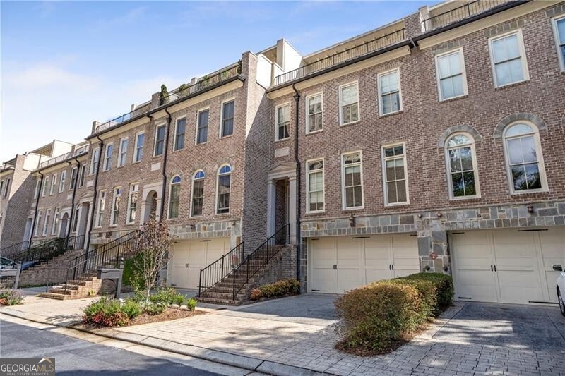 Located in the heart of Buckhead, this stunning four-level brownstone boasts an elevator to all floors, soaring ceilings, and an abundance of natural light. Hardwood floors flow seamlessly throughout, while the gourmet Viking kitchen features a gas range, double ovens, microwave, and dishwasher-perfect for entertaining. The spacious family room and oversized primary suite offer comfortable luxury, complemented by a spa-like bath with a Jacuzzi tub and expansive shower. The terrace level includes a private guest suite with en-suite bath, and the bonus level offers an office/study with two expansive rooftop terraces showcasing breathtaking downtown views. Enjoy four outdoor decks/patios, a built-in gas grill, ample storage, and a two-car garage with EV charger. Just a short distance to shopping, restaurants, highway access, and much more, this home combines city convenience with unparalleled style and elegance.
