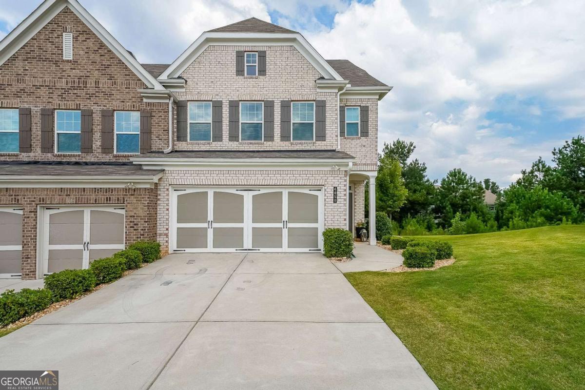 Welcome to Bryton Trace, a charming enclave of just 42 homes conveniently located in Cumming-less than 2 miles from GA 400, The Collection at Forsyth, and Halcyon. With award-winning Forsyth County schools, shopping, and dining just minutes away, this community offers the perfect balance of comfort and convenience. This modern townhome features 4 spacious bedrooms, 3.5 bathrooms, and a versatile flex space that can be used as a home office, playroom, or media room. Inside, the open-concept layout is designed for today's lifestyle, with a chef's kitchen that seamlessly overlooks the family room and cozy fireplace. The kitchen shines with natural stone countertops, an oversized island with sink and pull-out trash bin, a large walk-in pantry, breakfast bar seating, and stainless steel appliances including a refrigerator, gas range, and dishwasher. Upstairs, the luxurious owner's suite provides a relaxing retreat with an oversized walk-in closet, double vanity, garden tub, and separate shower. The convenient second-floor laundry adds ease to everyday living, while additional details such as a mudroom off the two-car garage, a smart lock entry, and other smart home features elevate the home's modern appeal. Filled with natural light and thoughtful finishes throughout, this move-in ready townhome blends style, function, and location-making it the perfect place to call home.