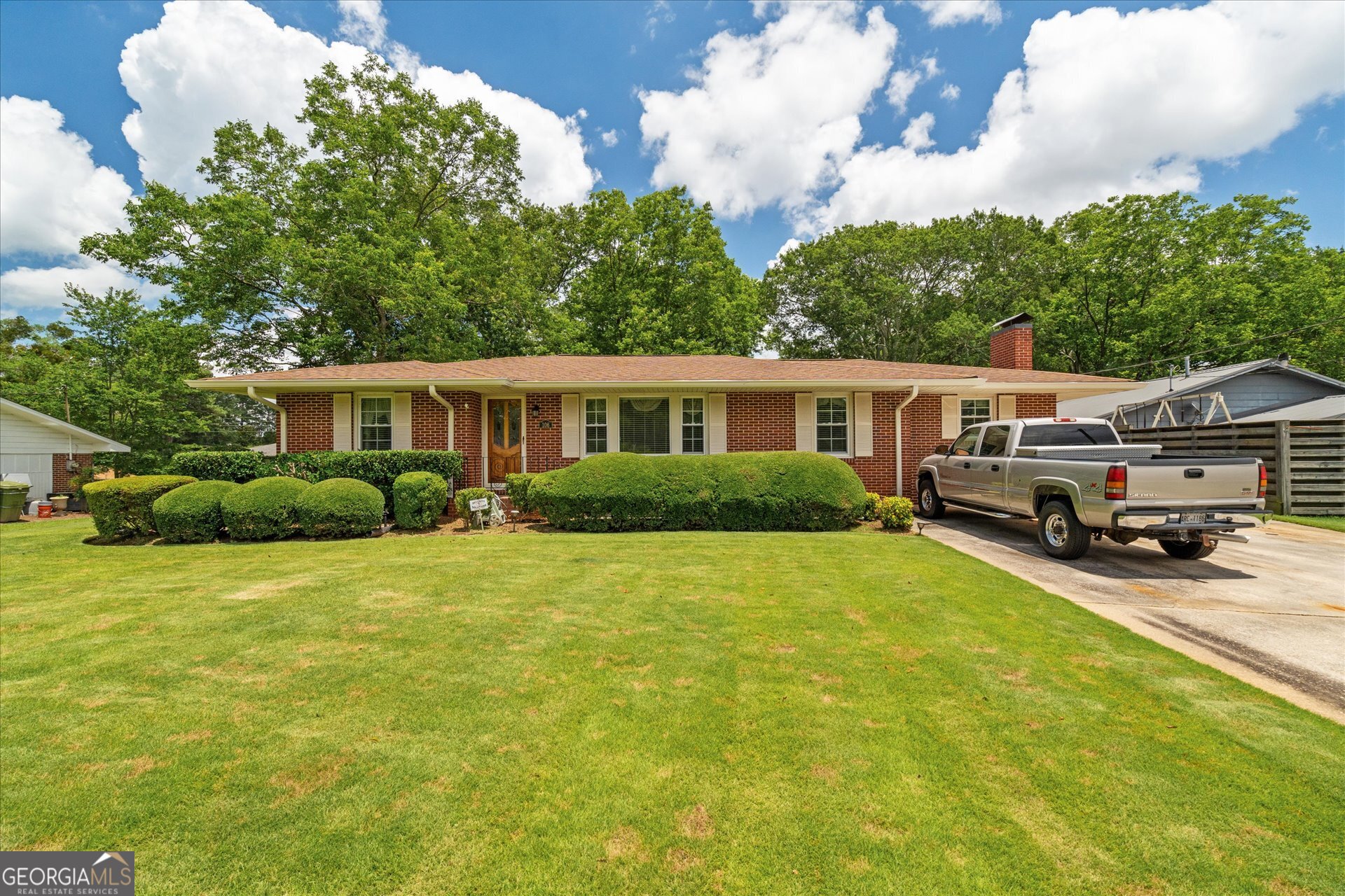 Timeless All-Brick Ranch. They don't build them like this anymore! This well-maintained 3-bedroom, 3-bath brick ranch sits on a beautifully landscaped lot in the award-winning Carrollton City School District-just minutes from Lake Carroll, the Greenbelt, downtown, parks, and tennis courts. Enjoy mature trees, flowering shrubs, and a fully fenced backyard with a drilled well for irrigation. Inside, you'll find original hardwoods, a stone fireplace, and built-ins full of character. A detached 2-car garage with workshop space and a gated courtyard add extra charm and function. Walk to the lake, playgrounds, and more-classic quality in a location you'll love.
